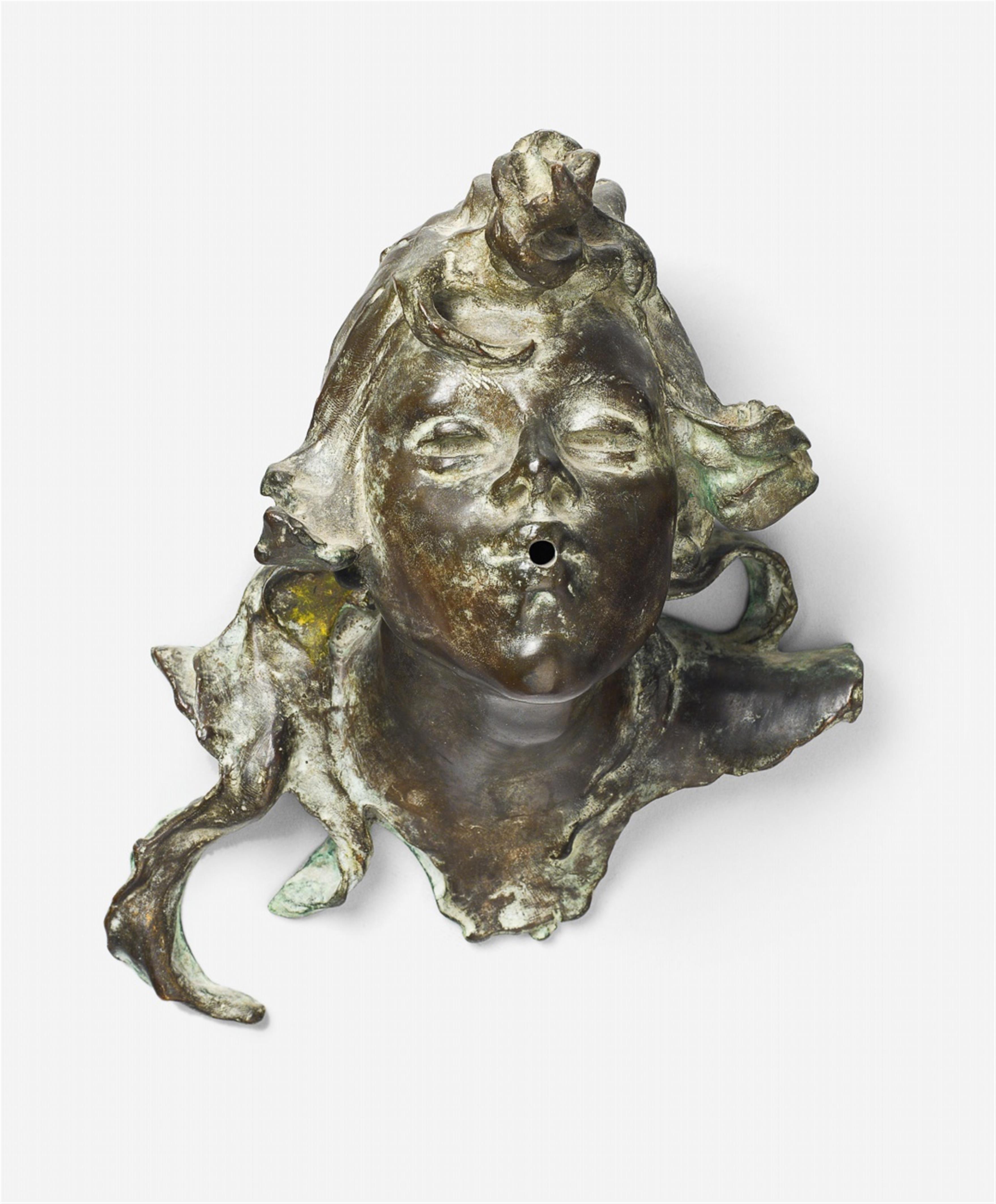 A bronze candle sconce mounting formed as the head of a triton. - image-1