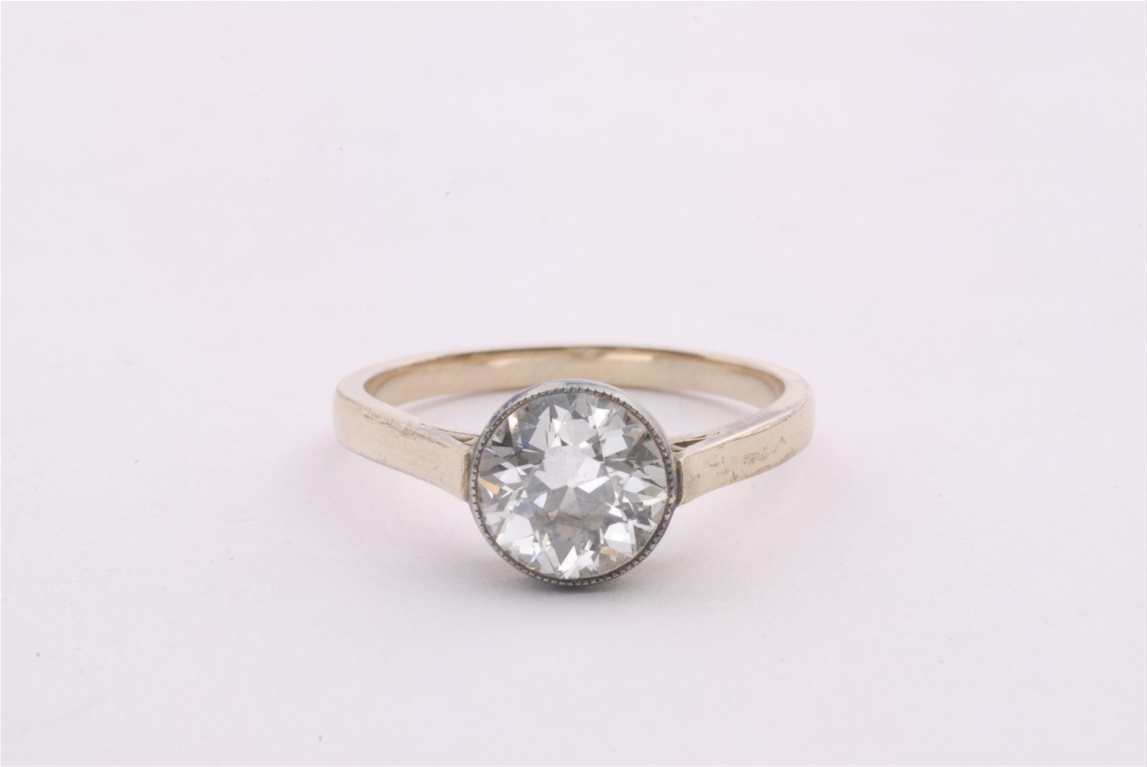 A 14k gold and silver diamond solitaire ring. - image-1