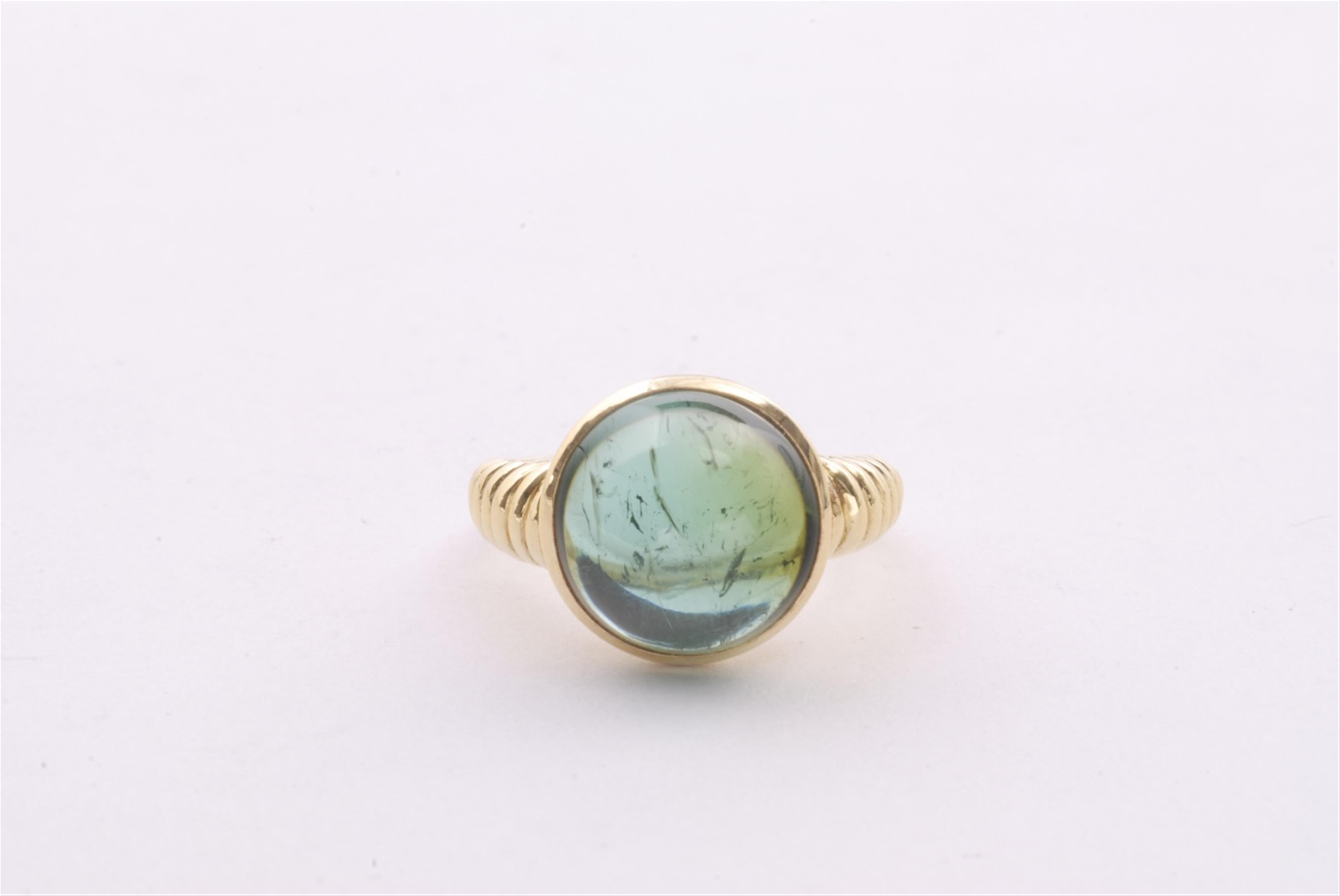 An 18k gold and green tourmaline ring. - image-1