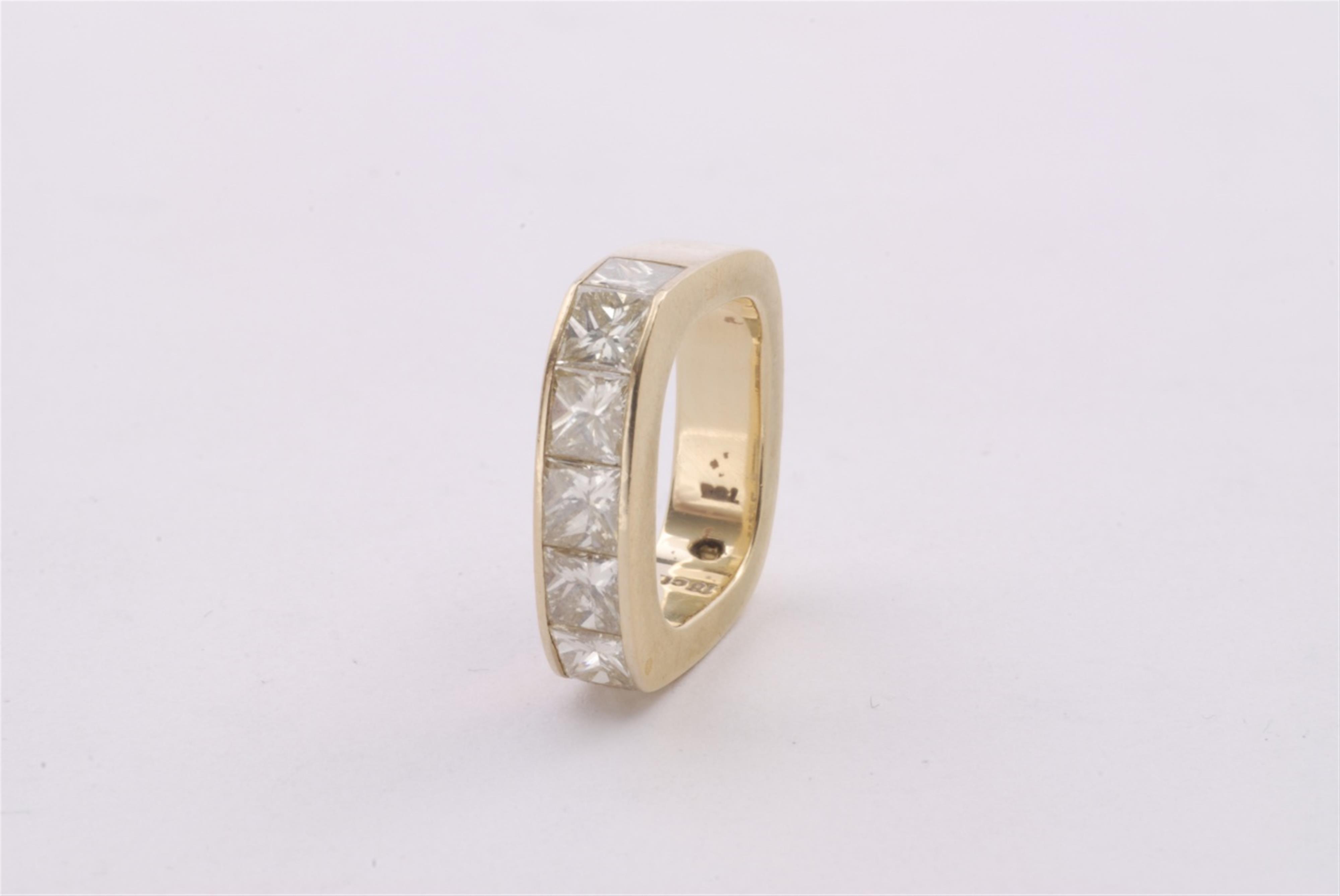 An 18k gold and diamond eternity ring. - image-1