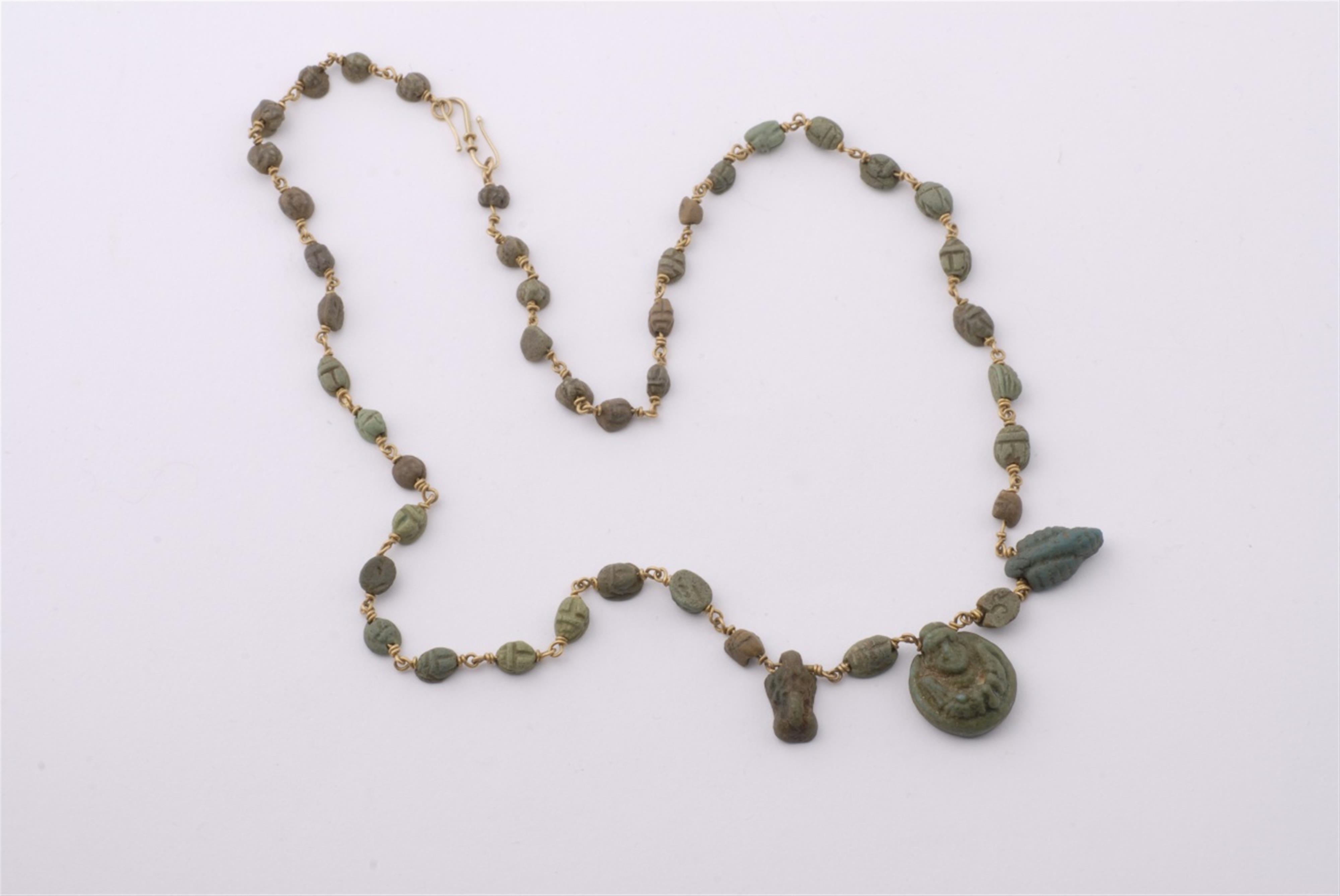 A fine gold chain necklace with ancient faience amulets. - image-1