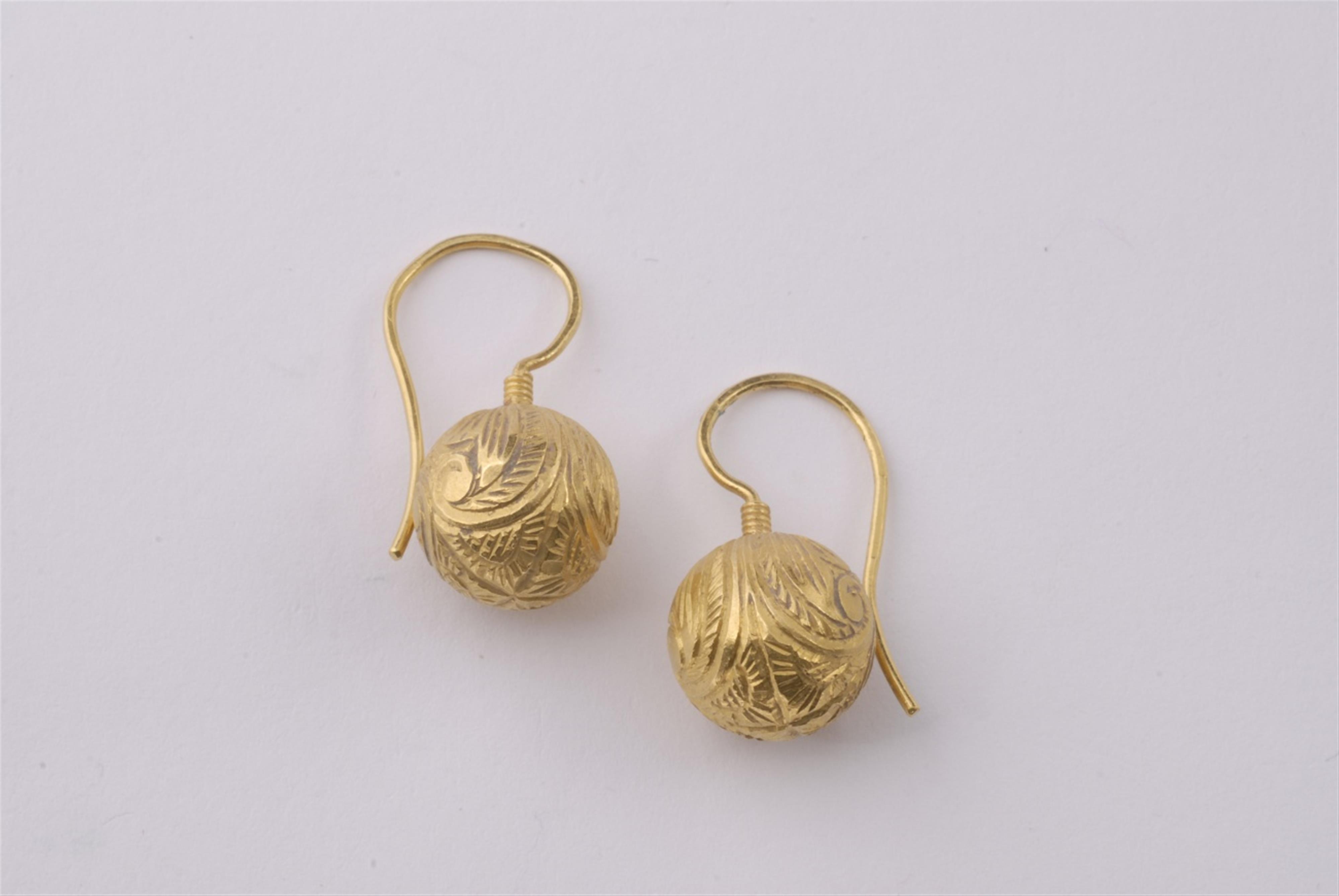 A pair of 24k gold earrings. - image-1