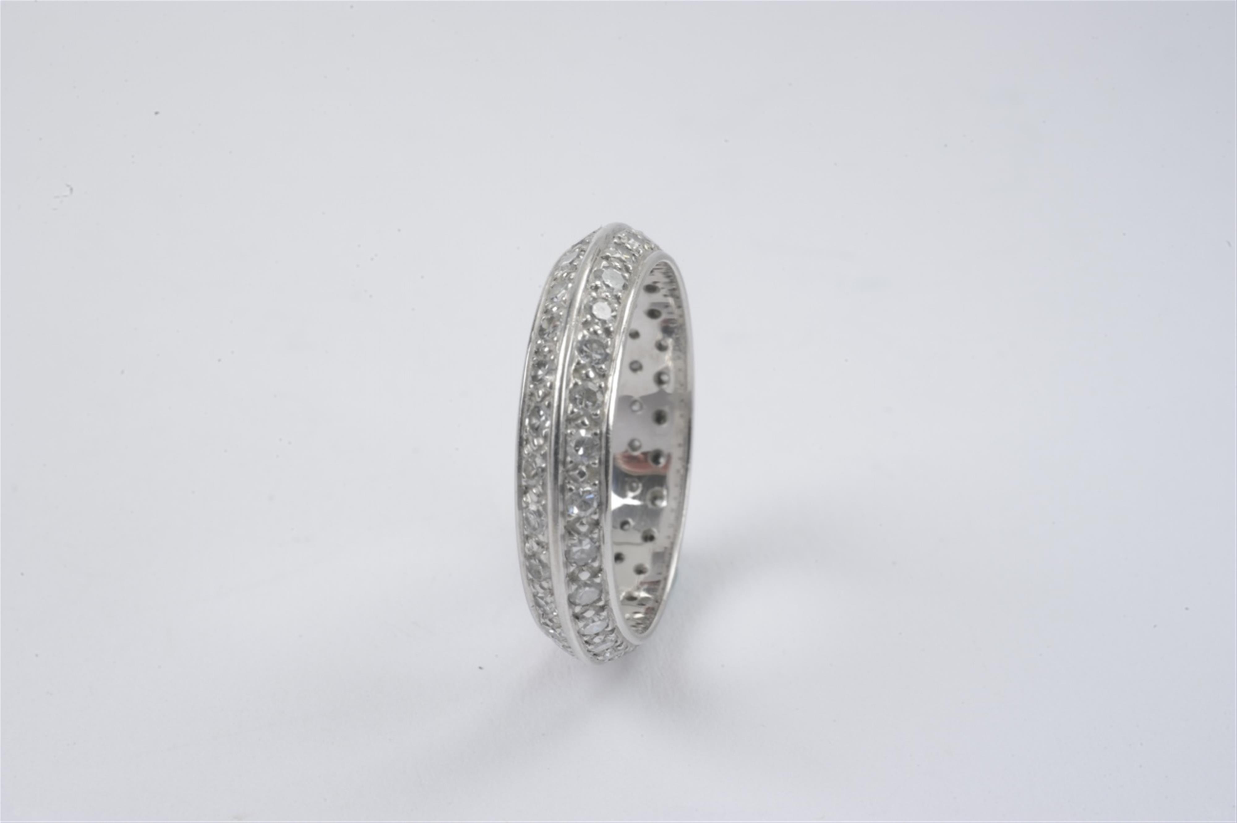 An 18k white gold and diamond eternity ring - image-2