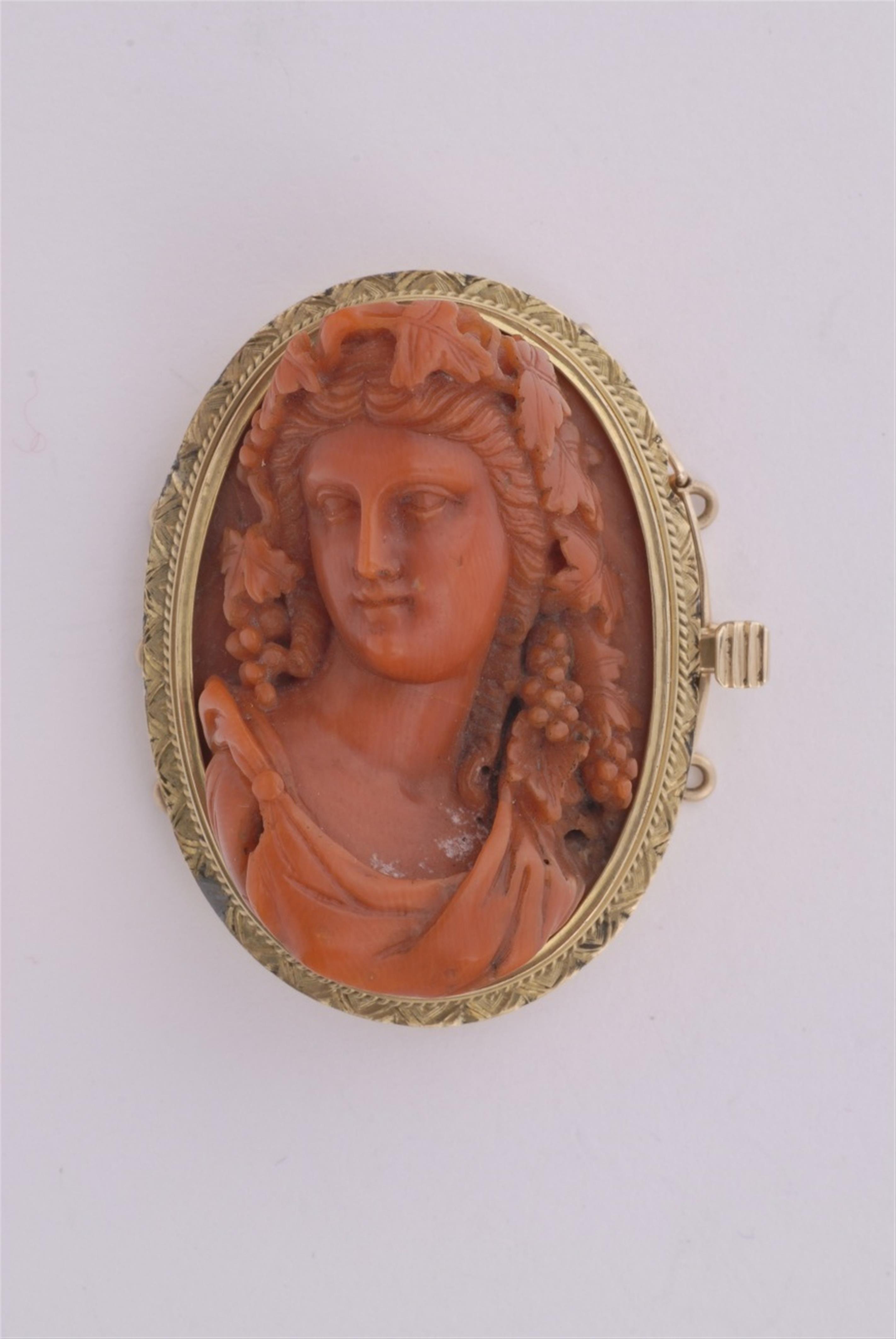 A 14k gold clasp set with a coral cameo. - image-1