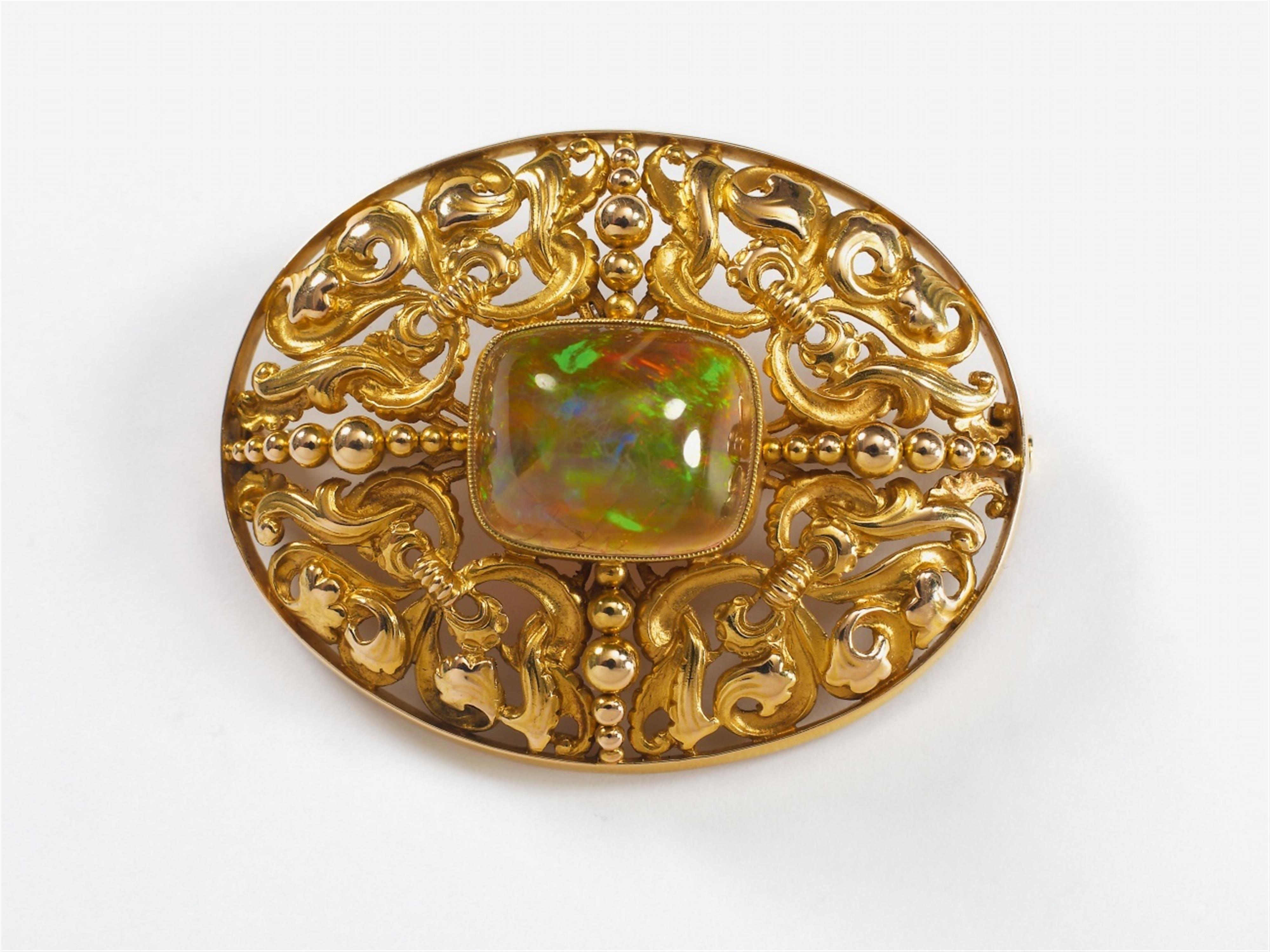 A 14k gold brooch with a large opal. - image-1