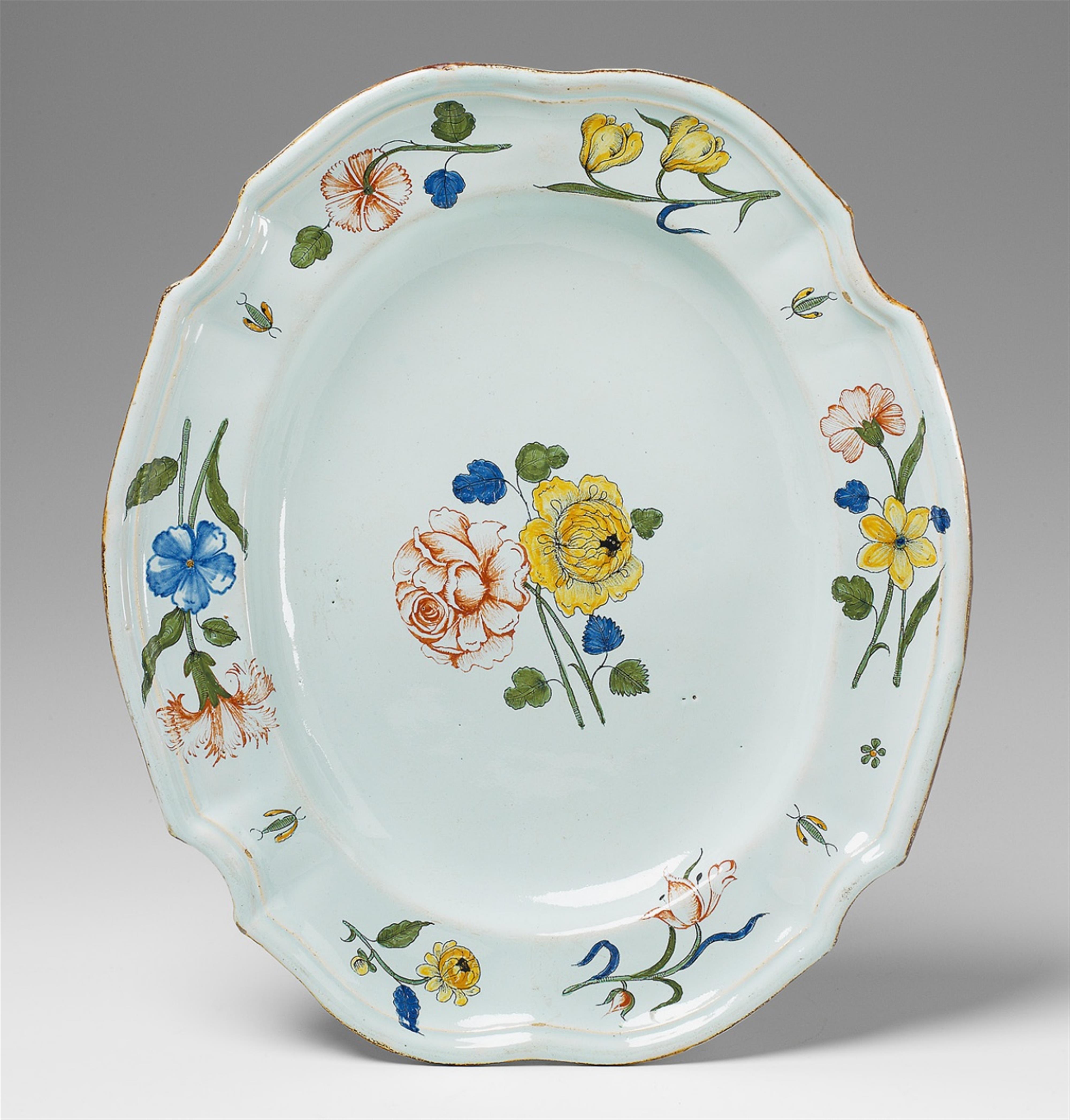 An oval faience charger with flower and insect "grand feu" decor. - image-1