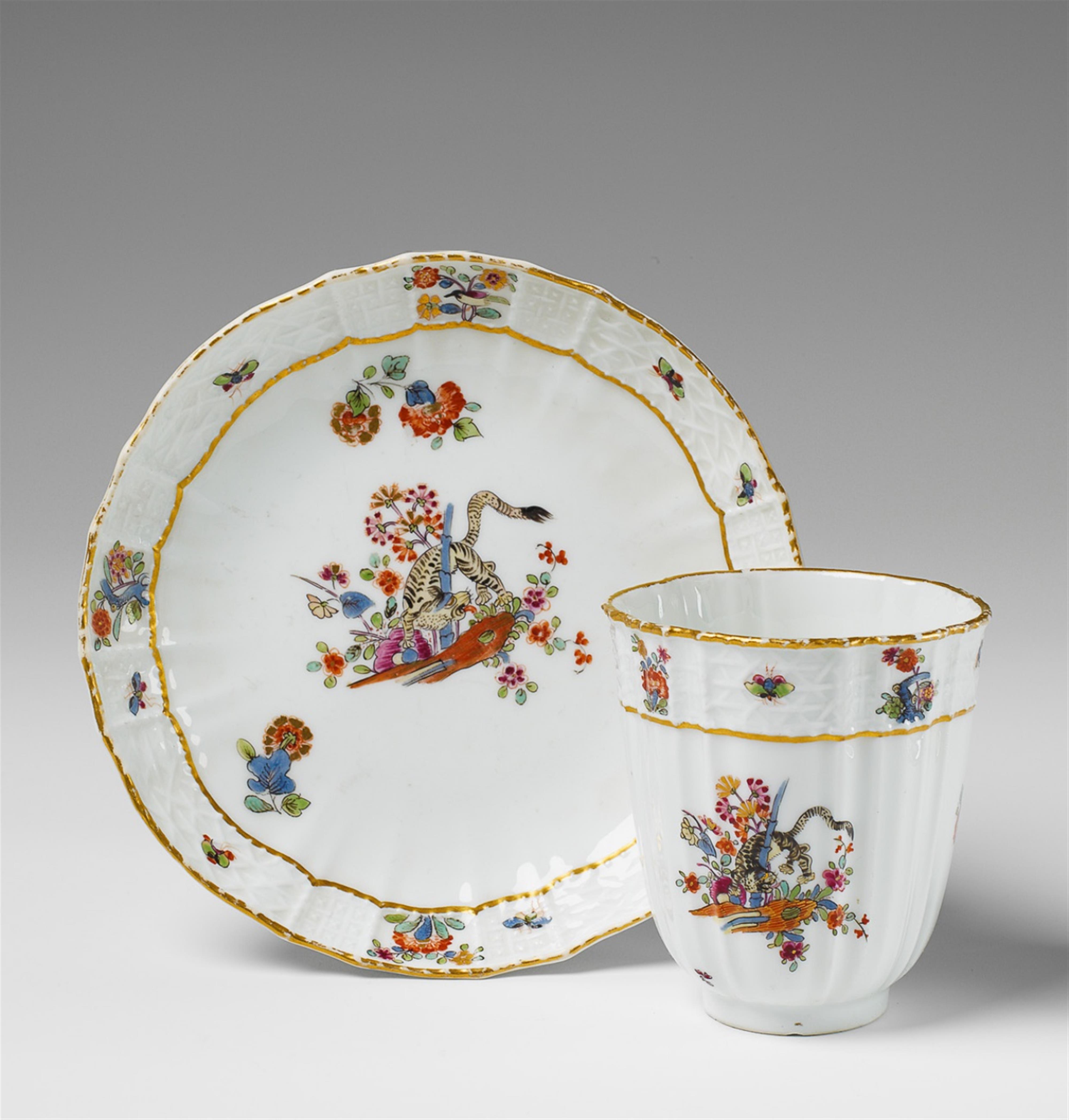 A Meissen porcelain cup and saucer with yellow lion decor. - image-1