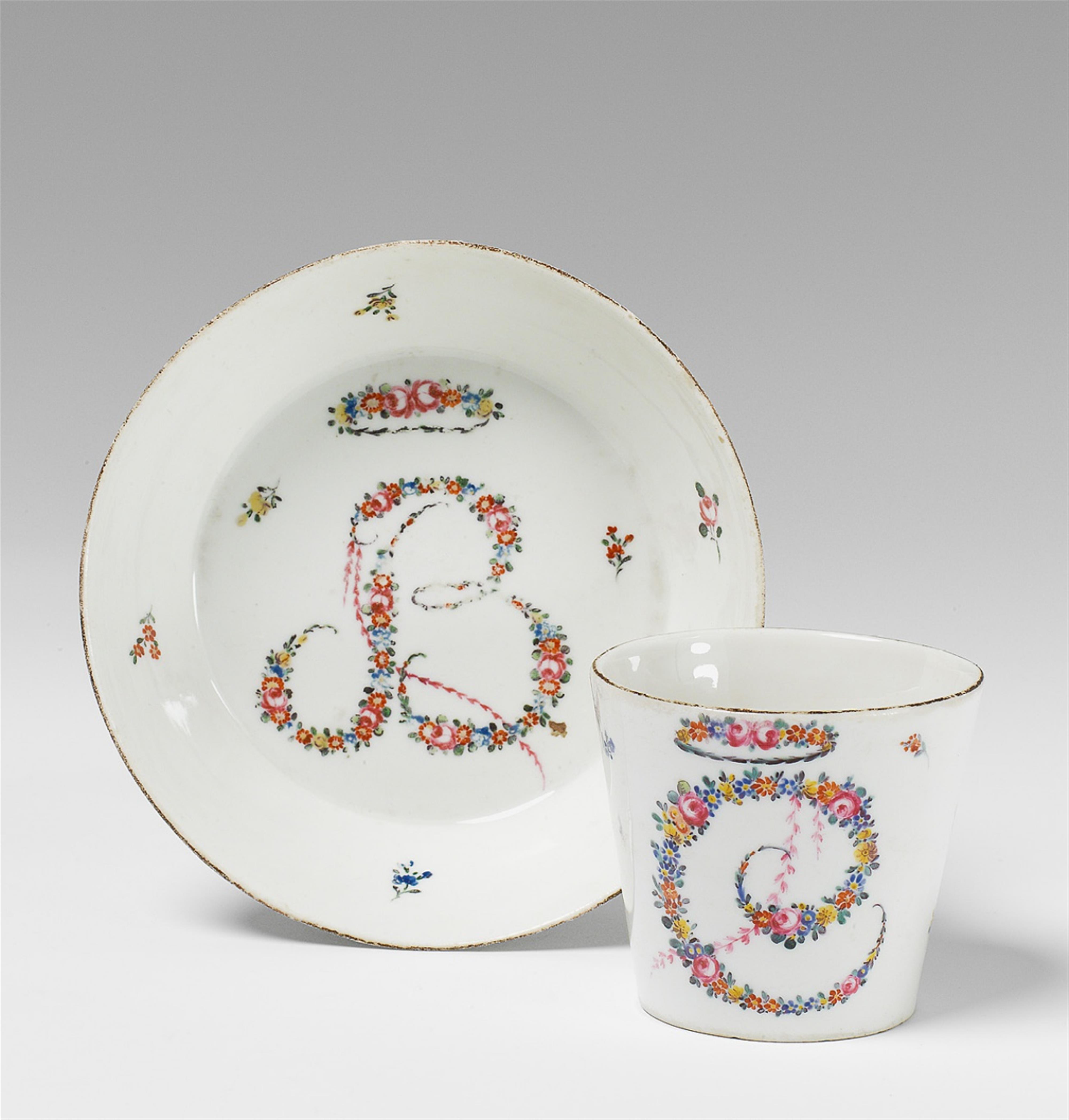 A Biedermeier Nymphenburg porcelain teacup and saucer with monograms. - image-1