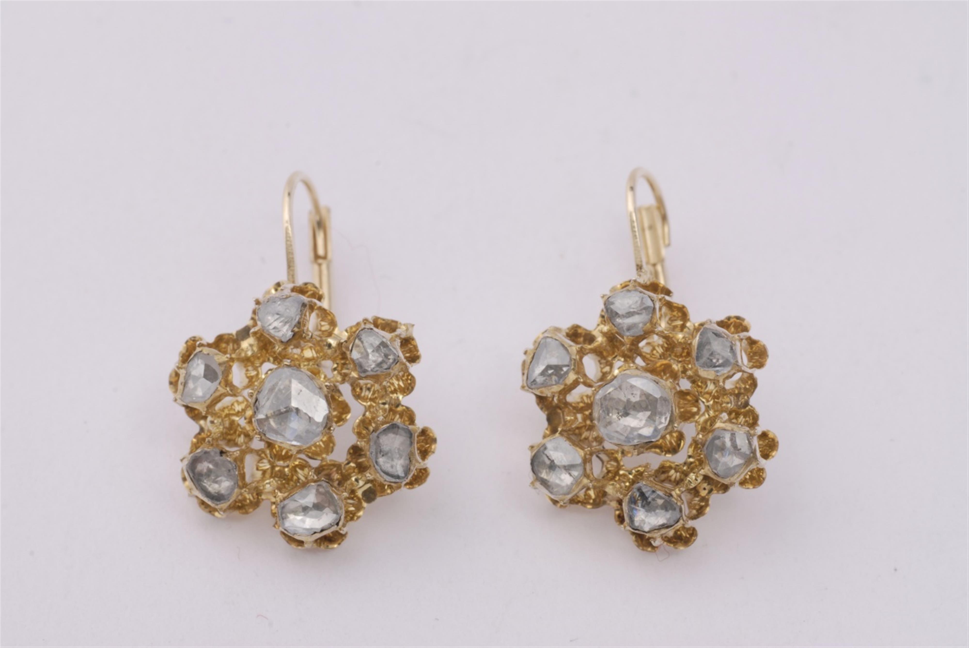 A pair of 14k gold and diamond earrings. - image-1