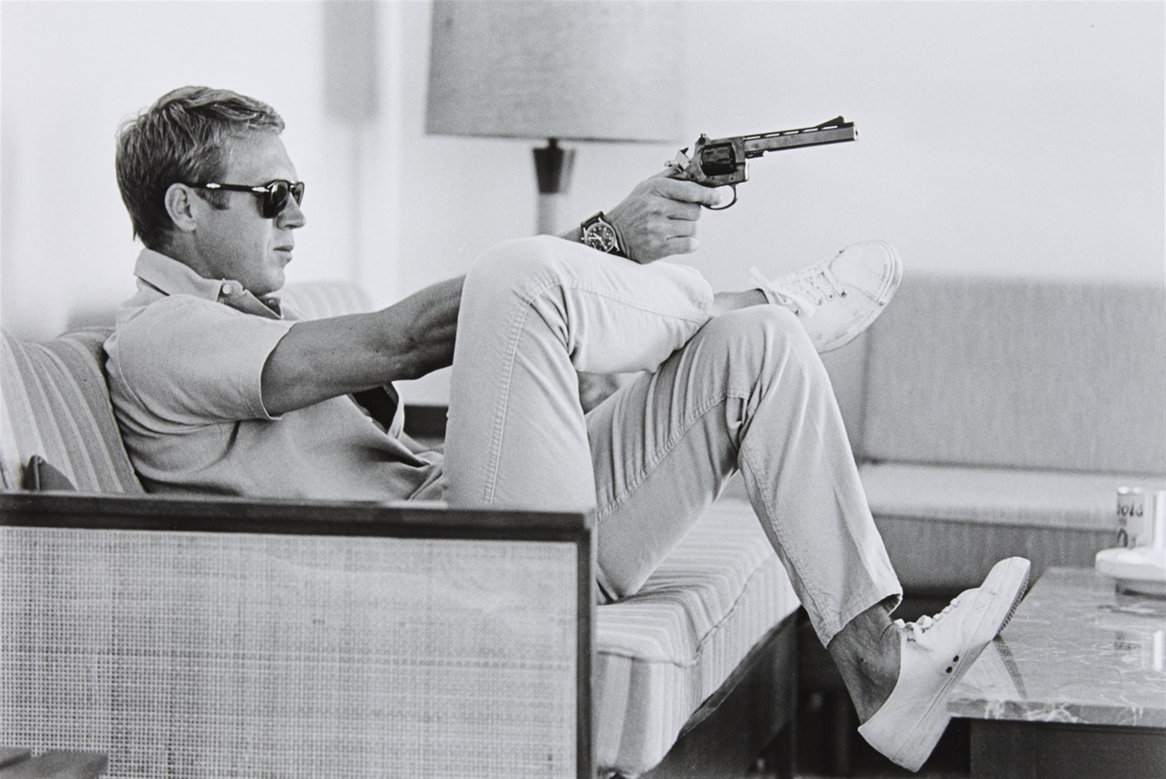John Dominis - Steve McQueen aims a pistol in his living room, CA - image-1