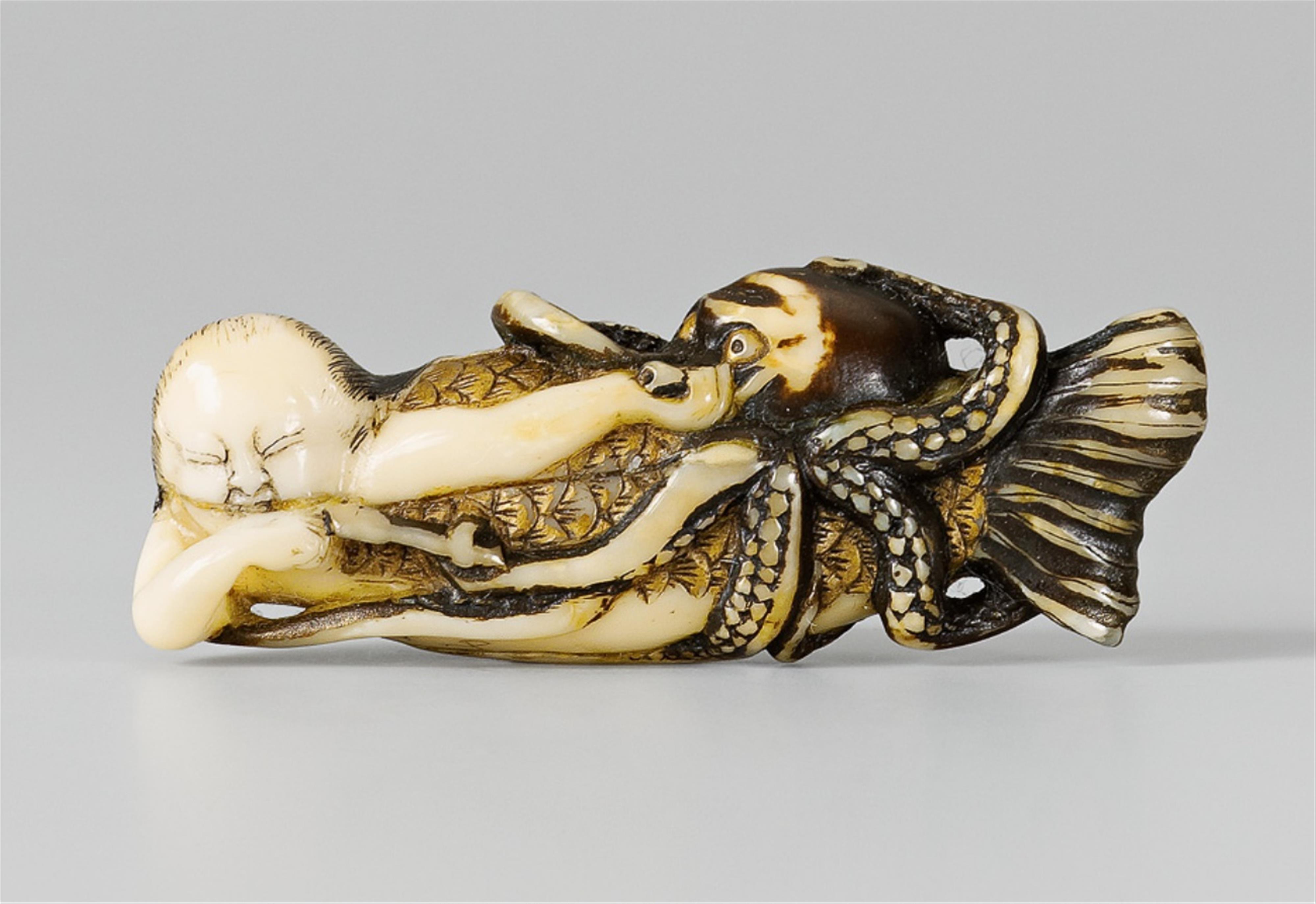 A rare marine ivory netsuke of a ningyo being attacked by an octopus. 18th/19th century - image-1
