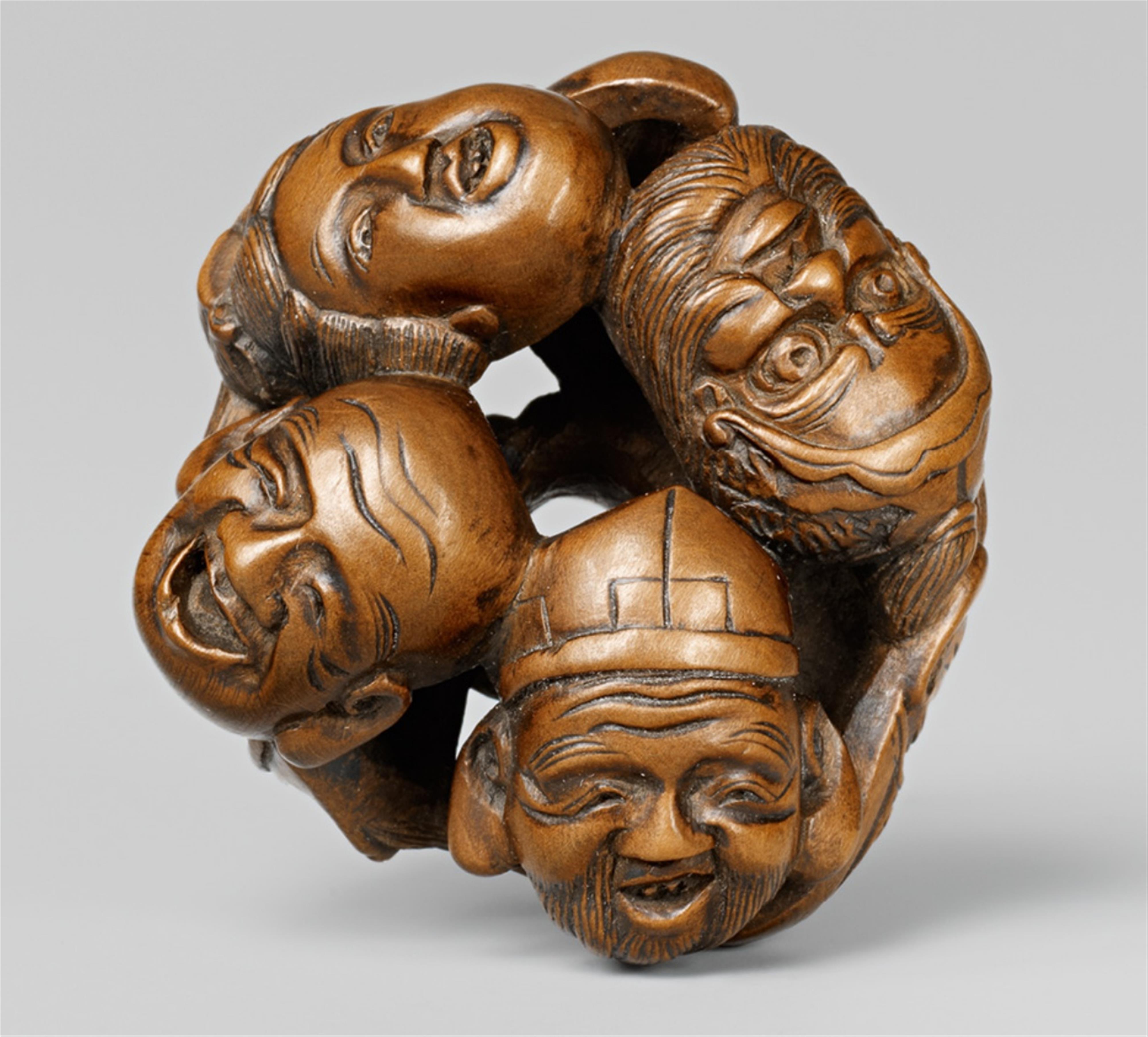 An unusual boxwood manjû-type netsuke of the heads of the Seven Gods of Good Luck, by Hôkei. Mid-19th century - image-1