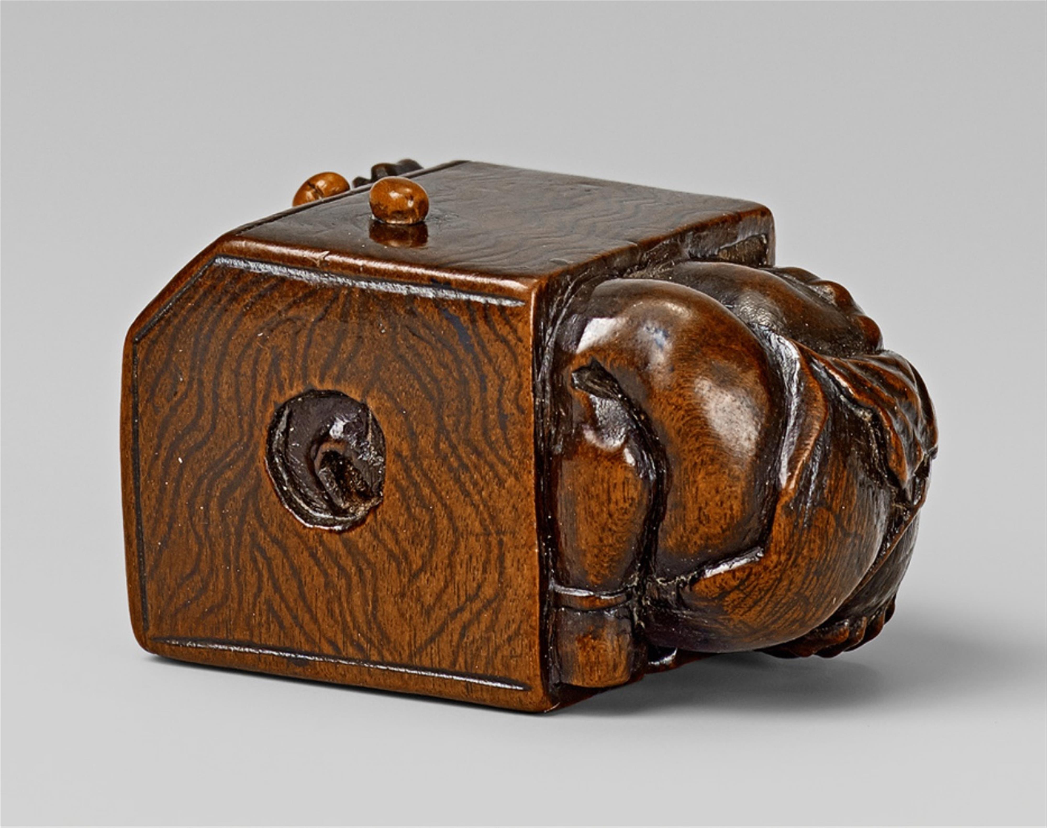 A Nagoya school wood netsuke of an oni in a portable heater, by Masajo. Mid-19th century - image-1