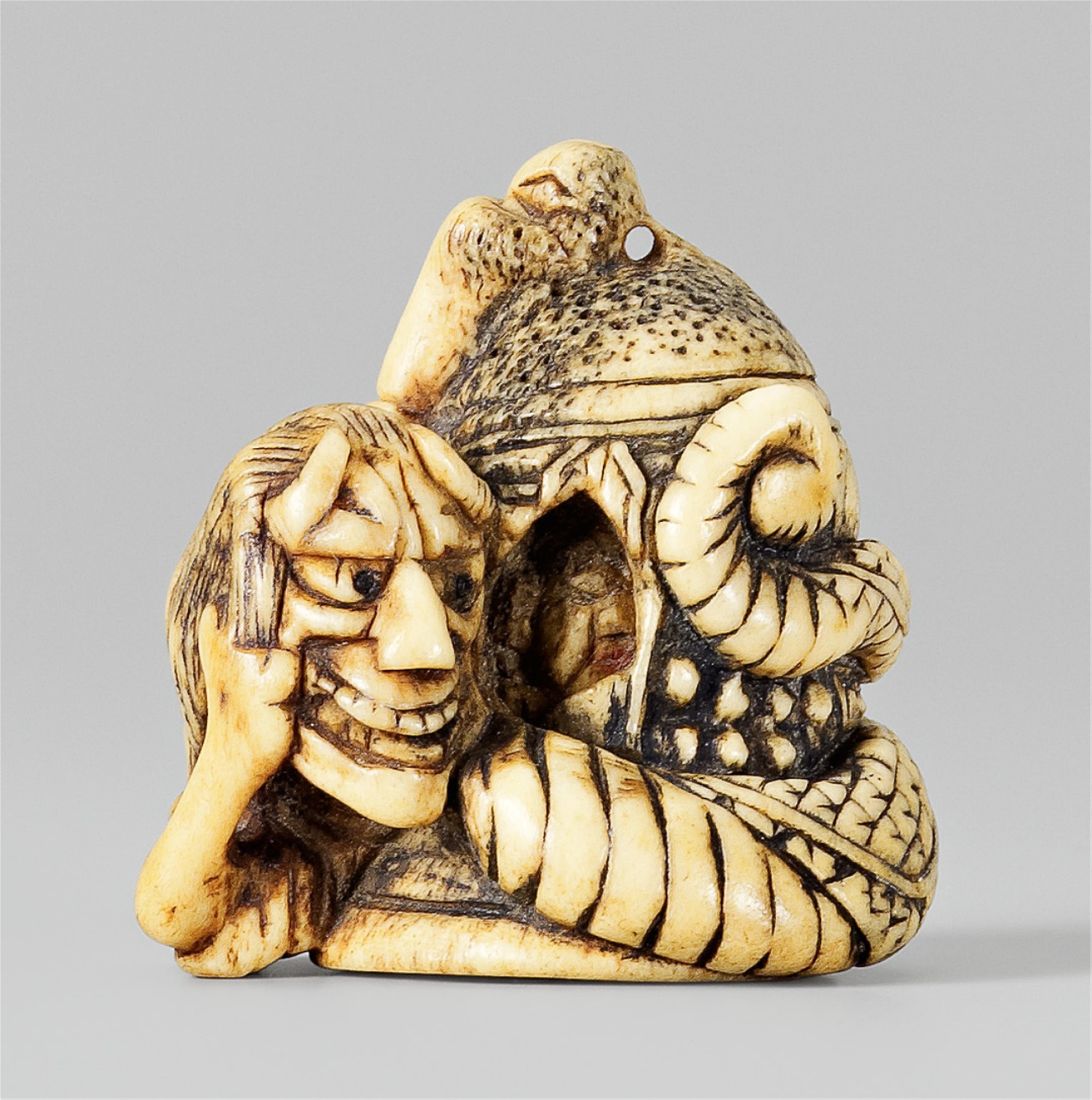 A stag antler netsuke of Kiyohime winding around a bell. 19th century - image-1