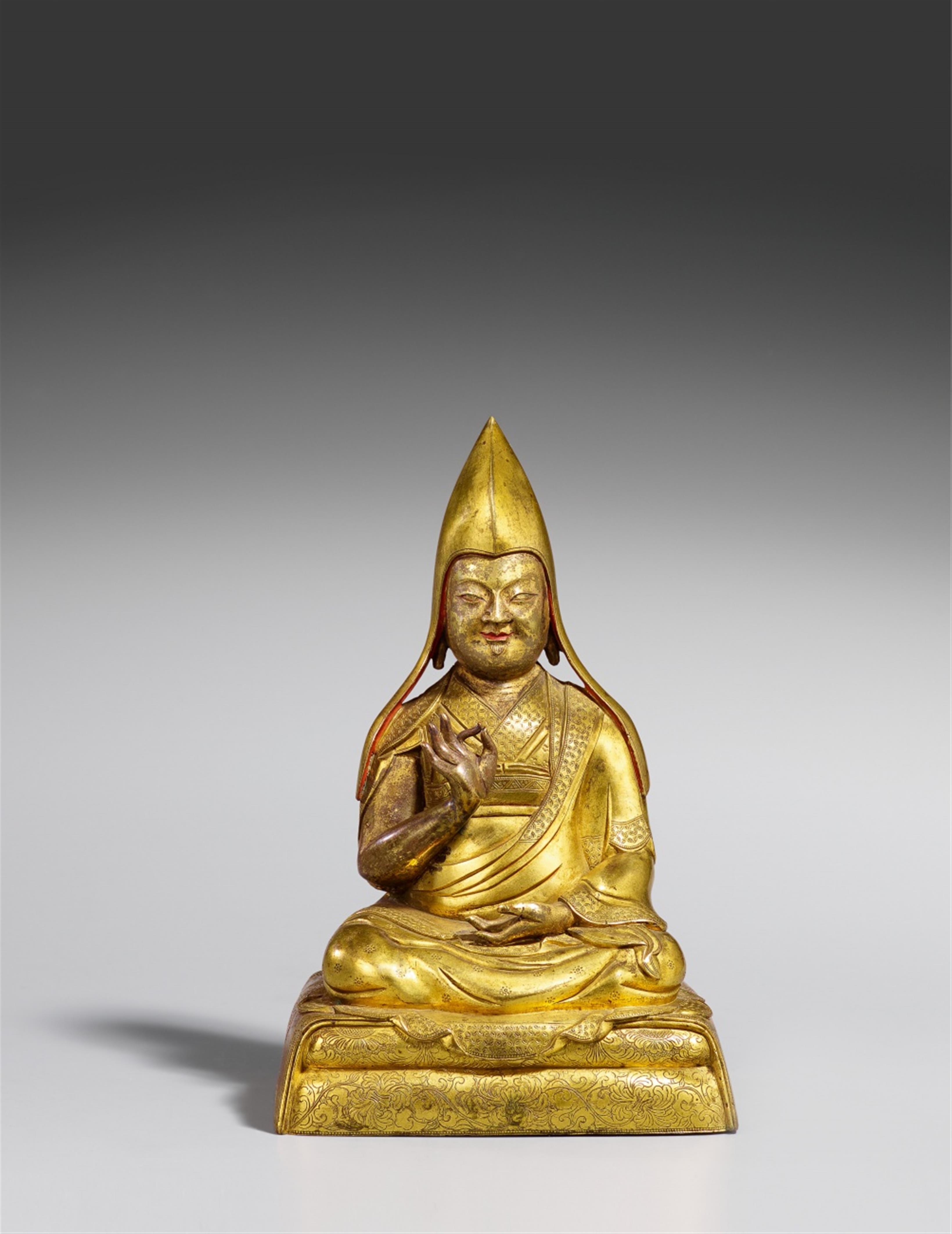 A Sinotibetan heavily gilt bronze figure of a Gelugpa lama. 18th century - image-1