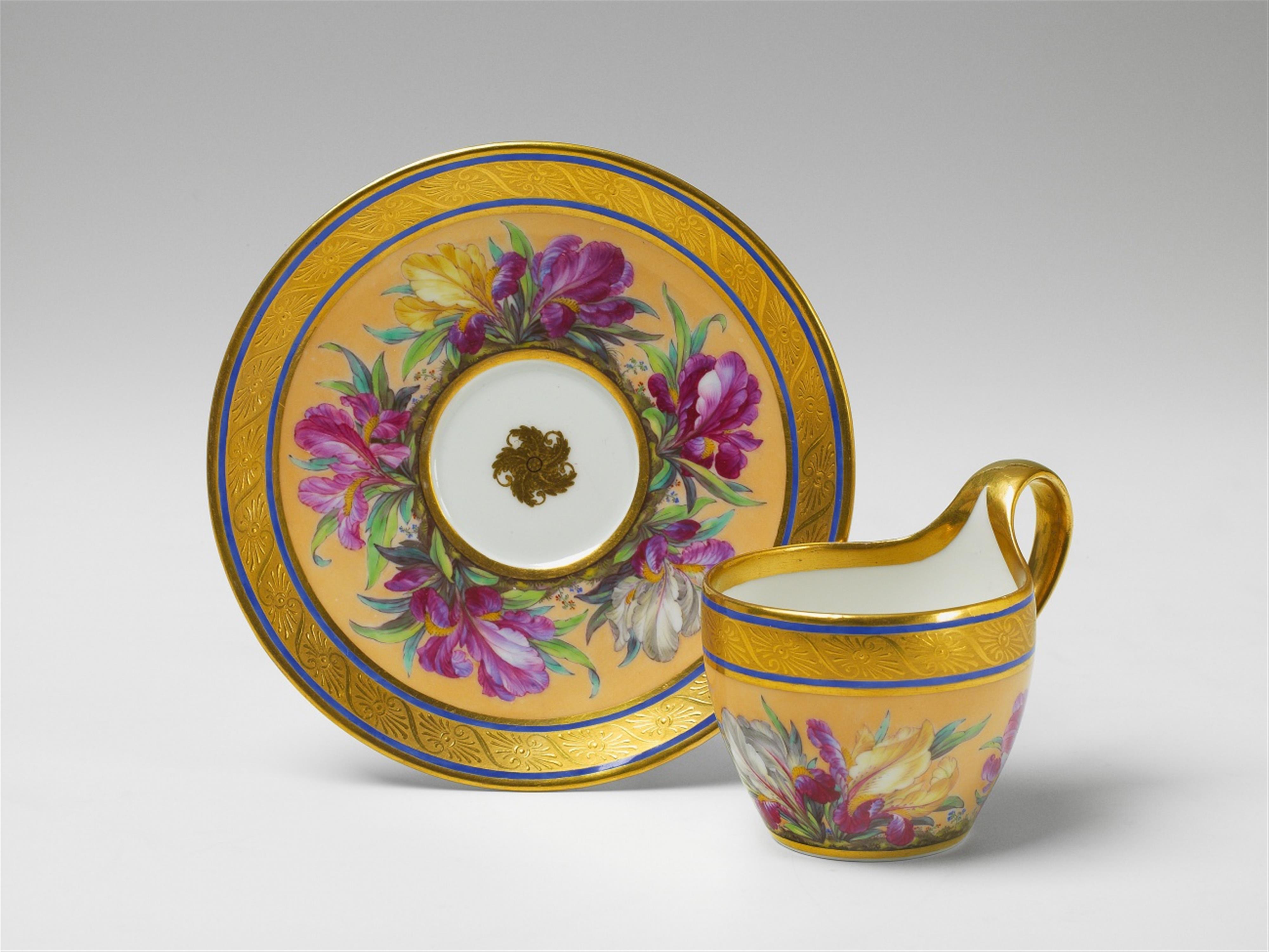 A Berlin KPM Campaner-form porcelain cup and saucer with lily decor. - image-1