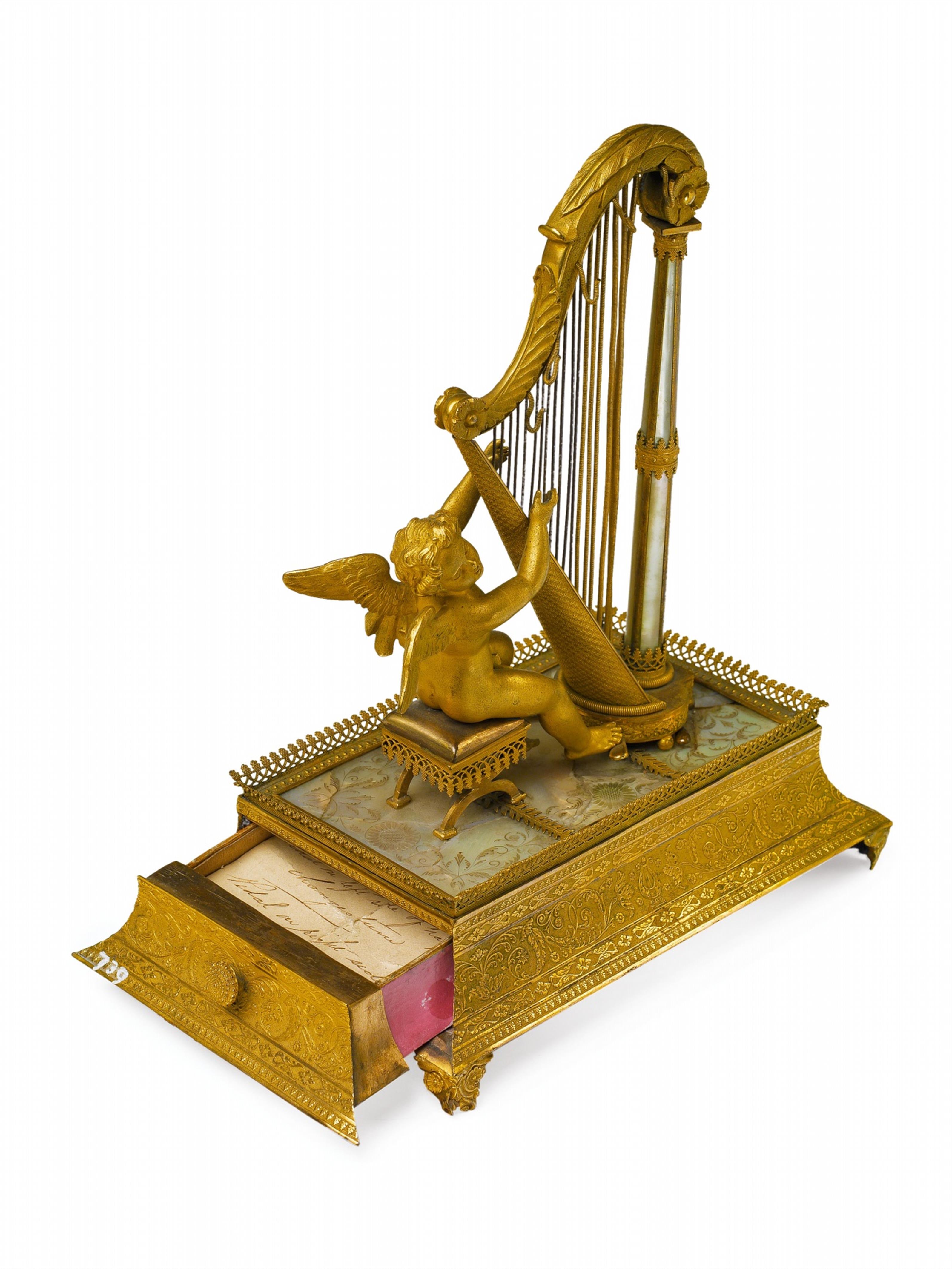 A fire-gilt bronze musical box formed as a putti playing a harp - image-2