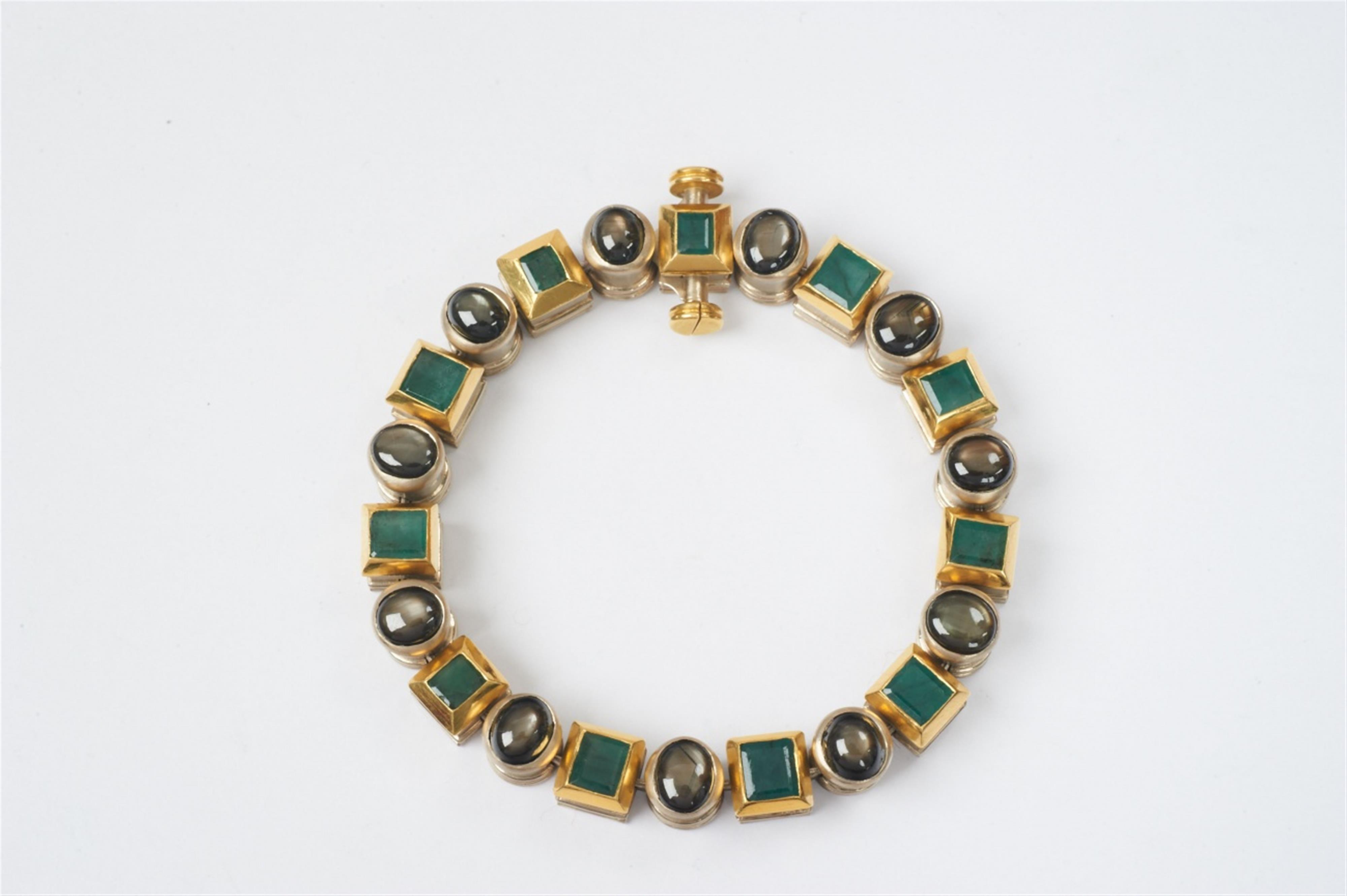 An 18k gold, black star sapphire and emerald bracelet by Wilhelm Nagel, Cologne - image-1