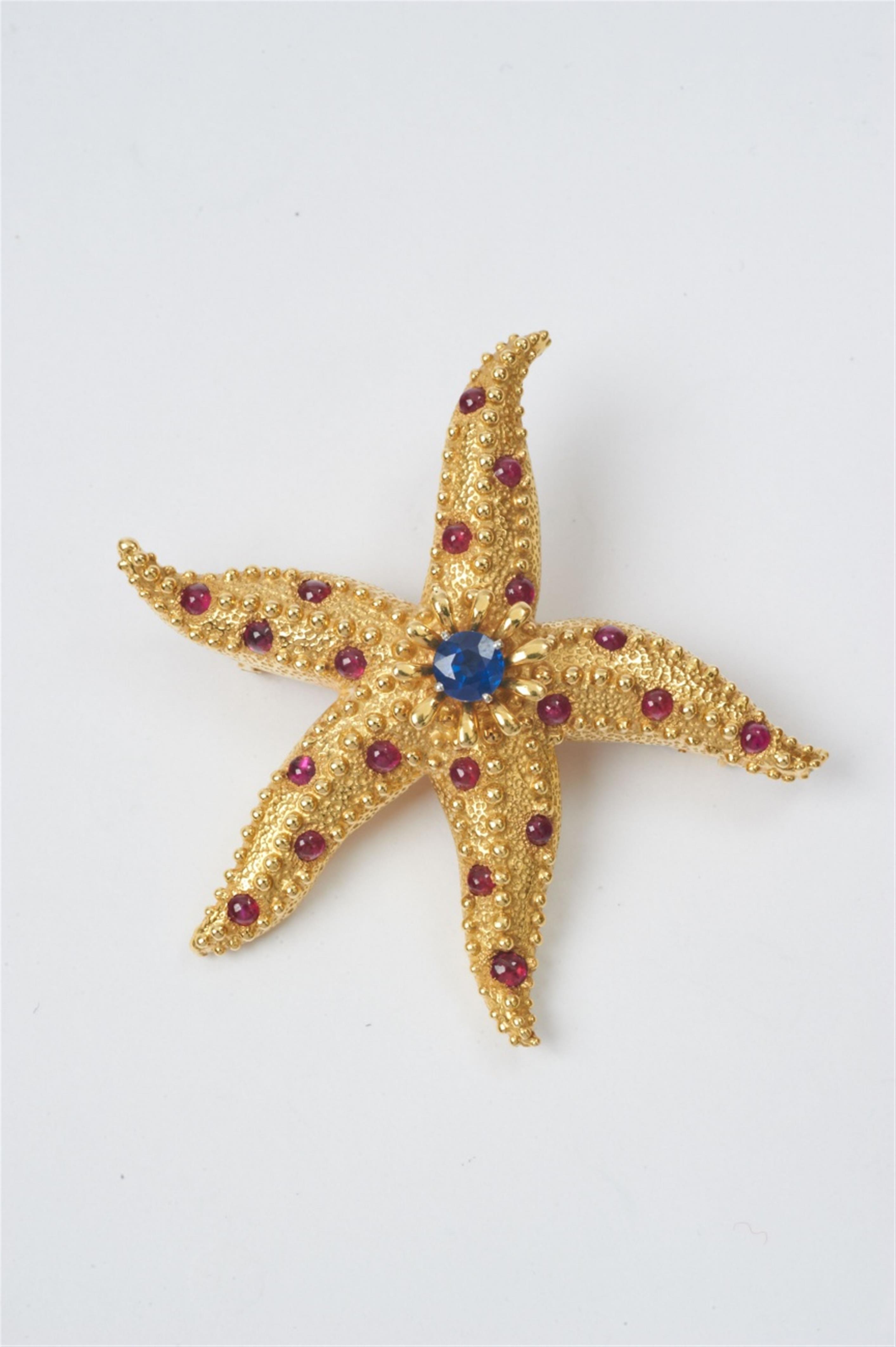 An 18k gold, ruby and sapphire "Starfish" clip brooch by Tiffany & Co with design by Jean Schlumberger - image-1