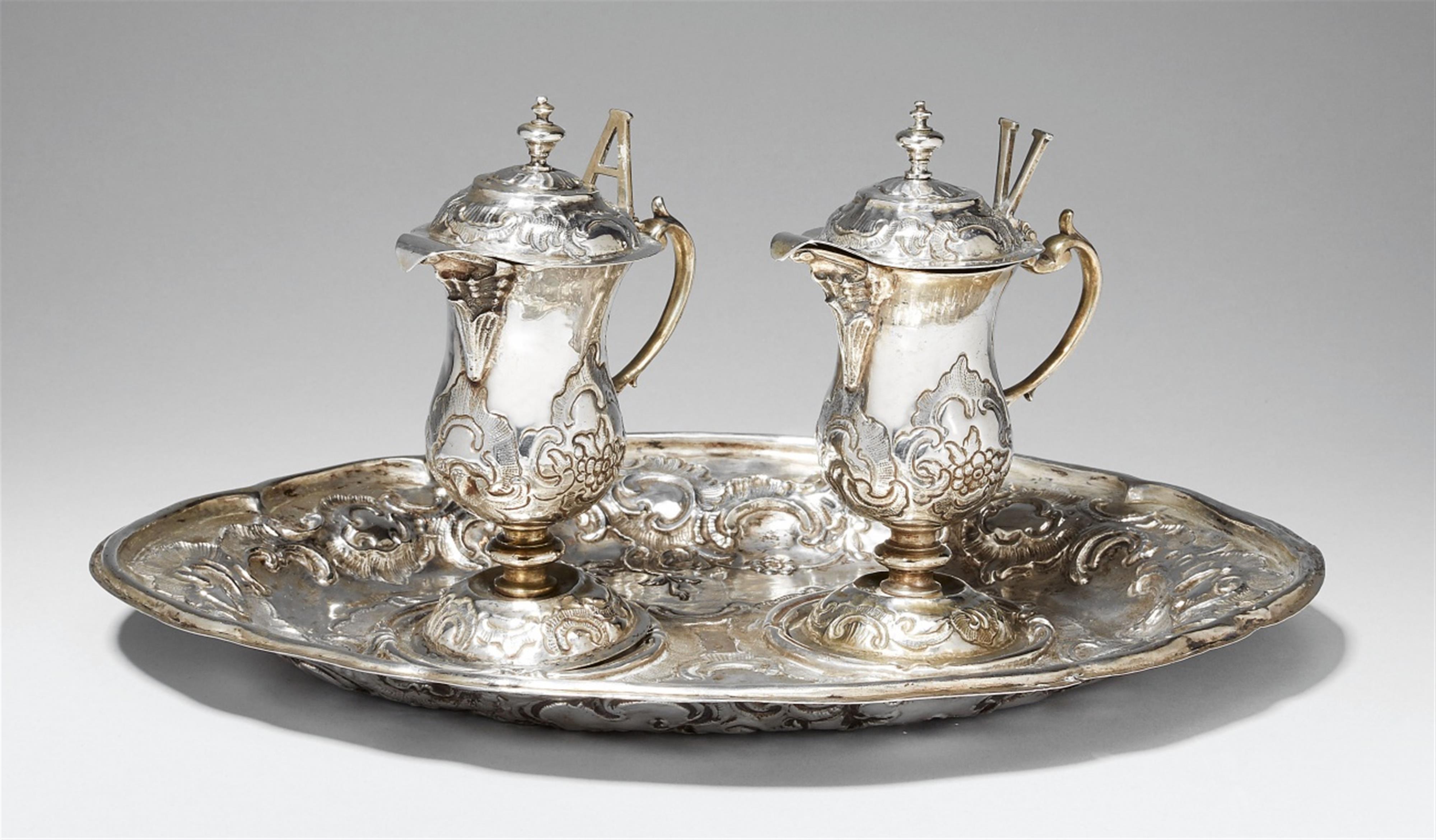 An Augsburg partially gilt silver communion garniture. Comprising wine and water jugs and a tray. With minor dents. Marks of Franz Anton Lang, 1767 - 69. - image-1