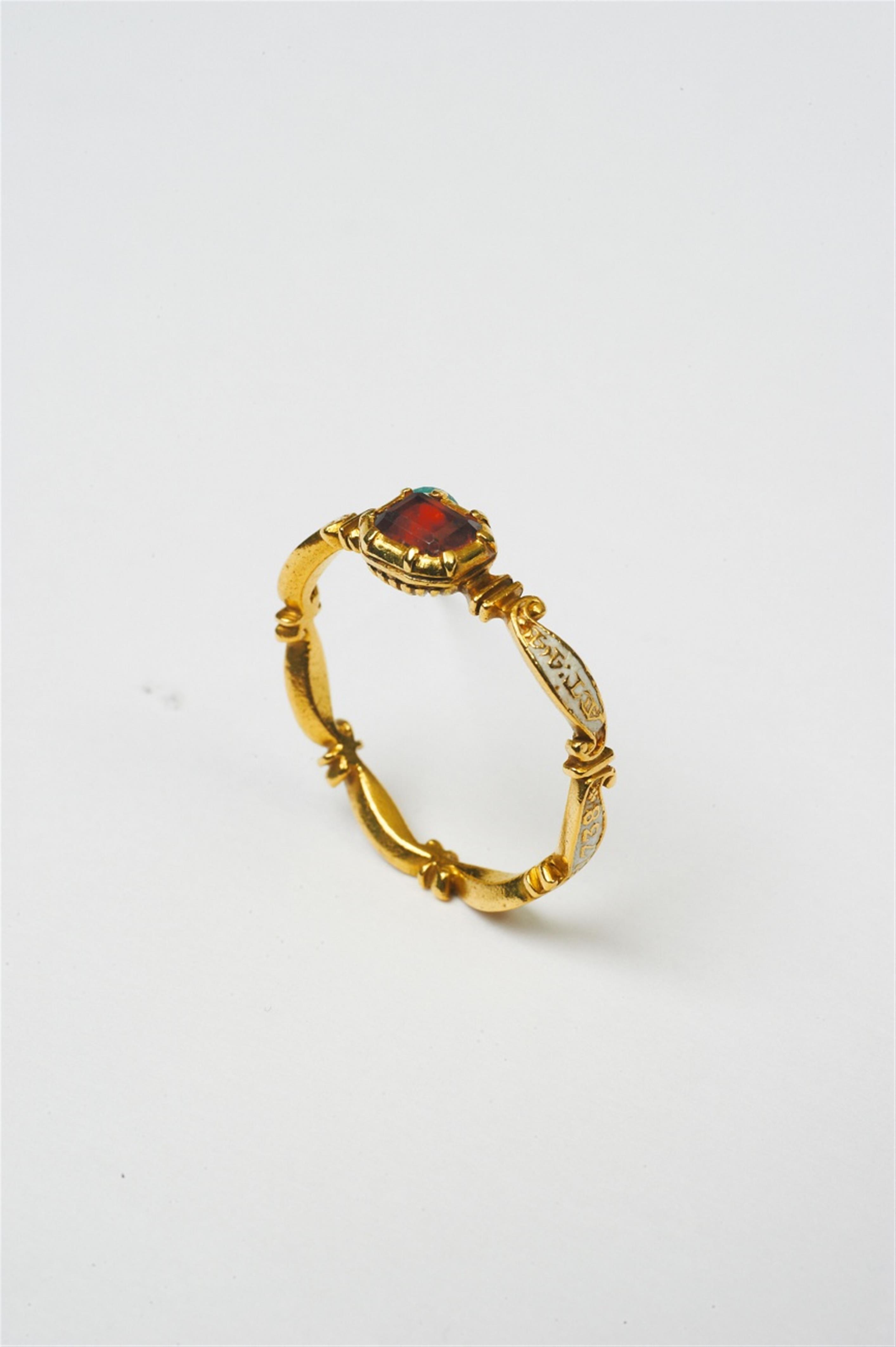 A Georgian gold enamel and garnet mourning ring - image-1