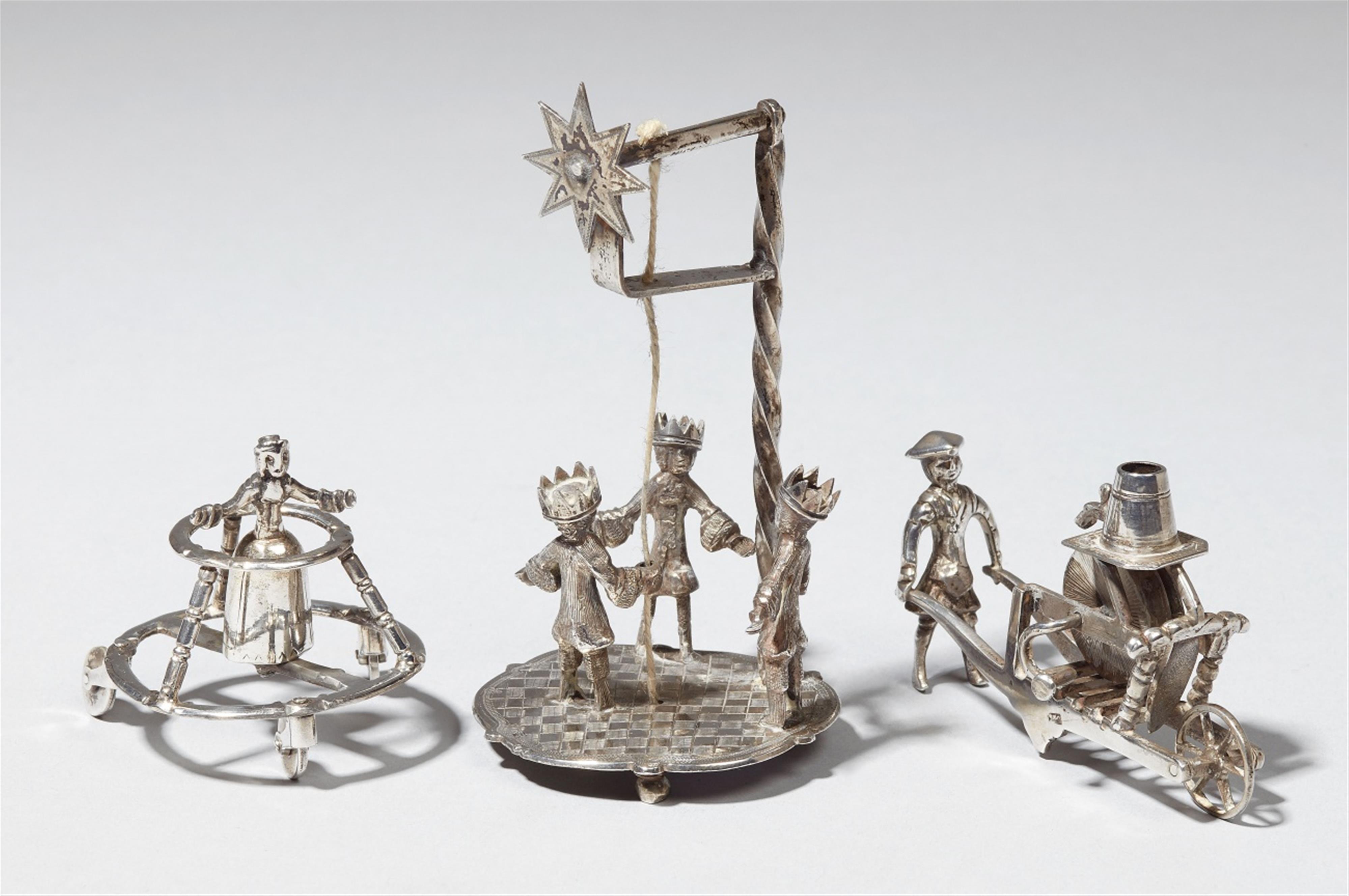 An Amsterdam silver miniature model of a child in a walker. Includes two 19th century miniatures. Marks of Arnoldus van Geffen, 1737. - image-1