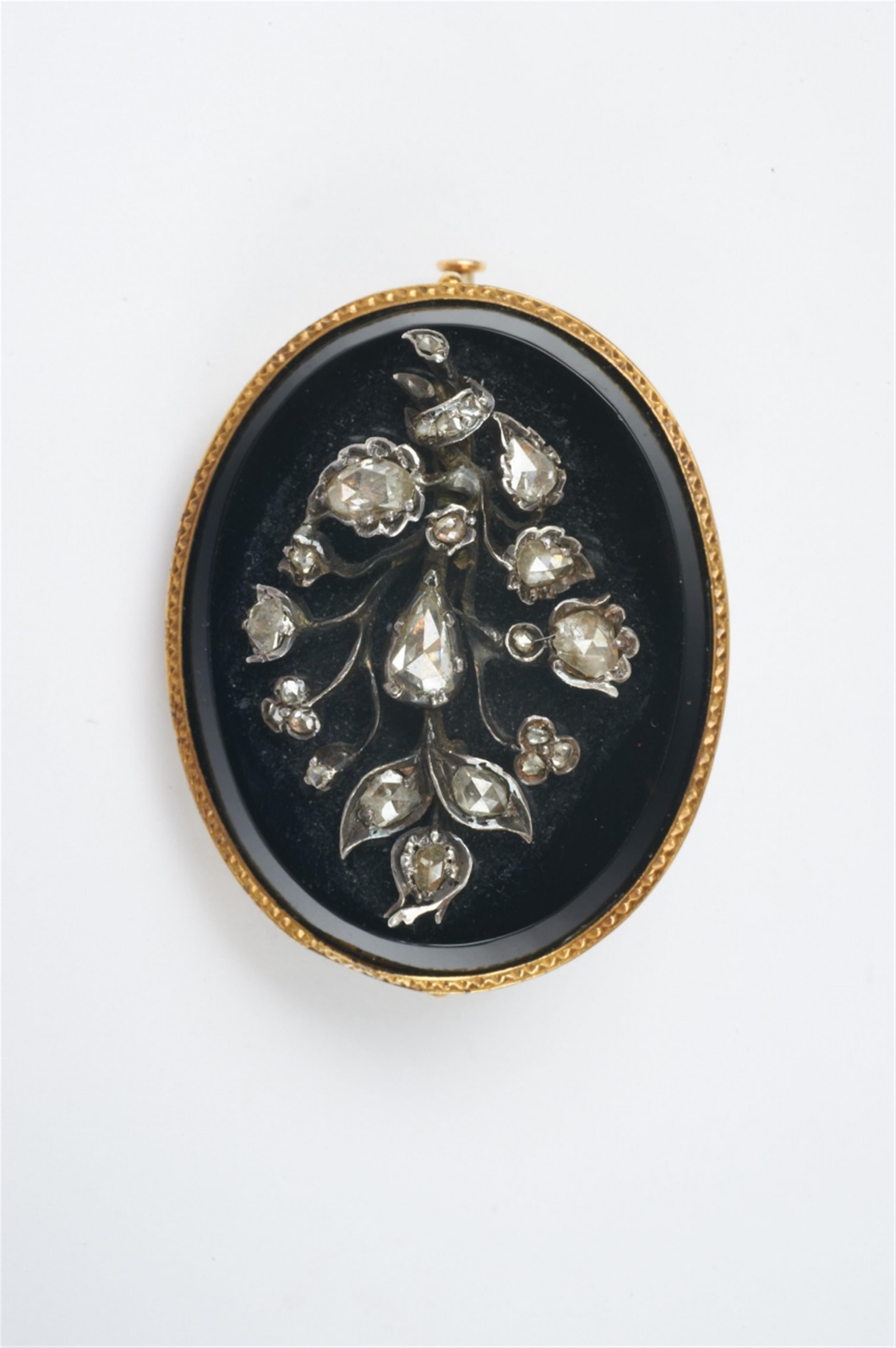 A 14k gold, silver, onyx and diamond brooch - image-1