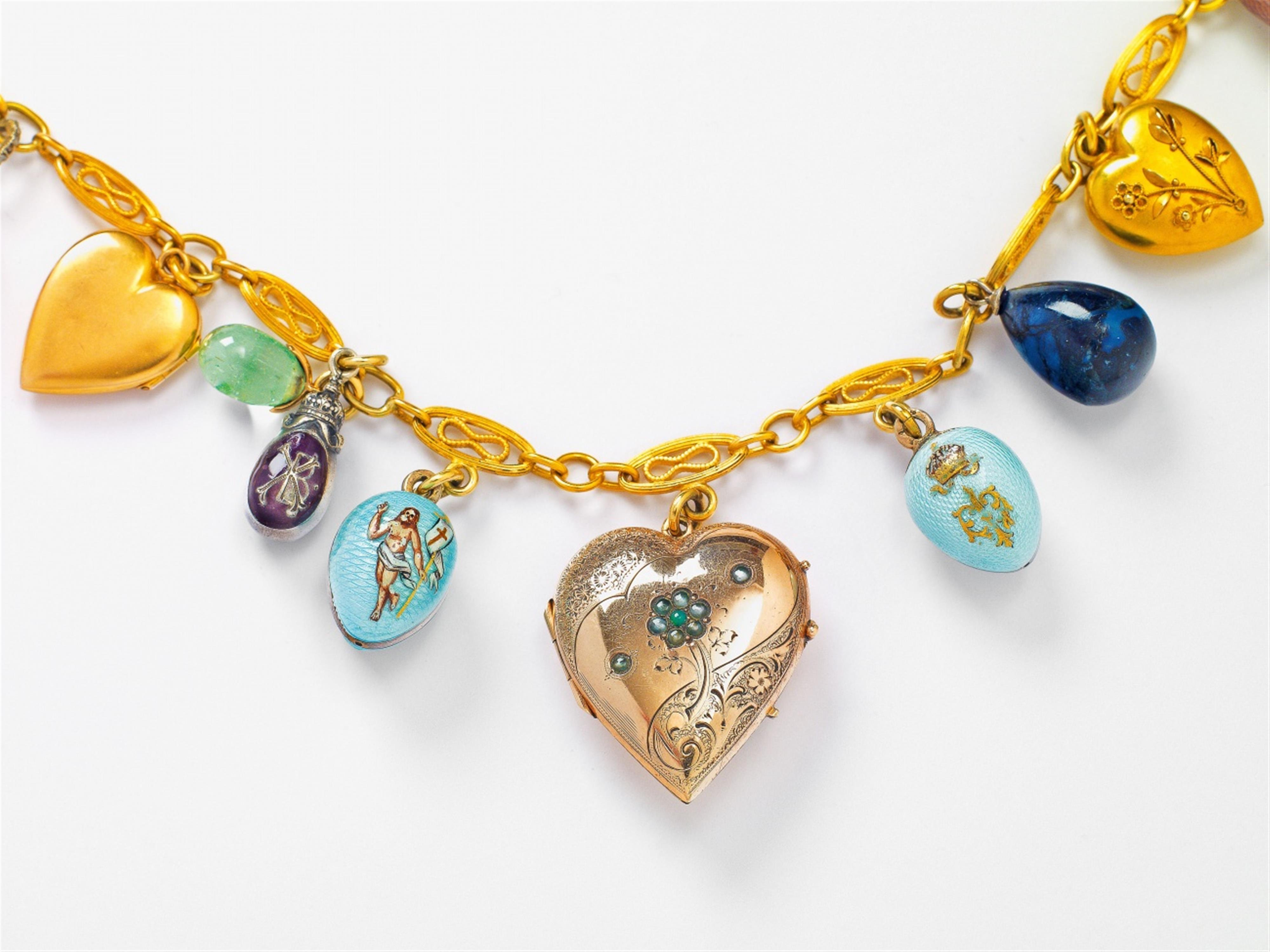 A gold, silver, enamel, gem-set charm necklace with egg- and heart-shaped pendants - image-3