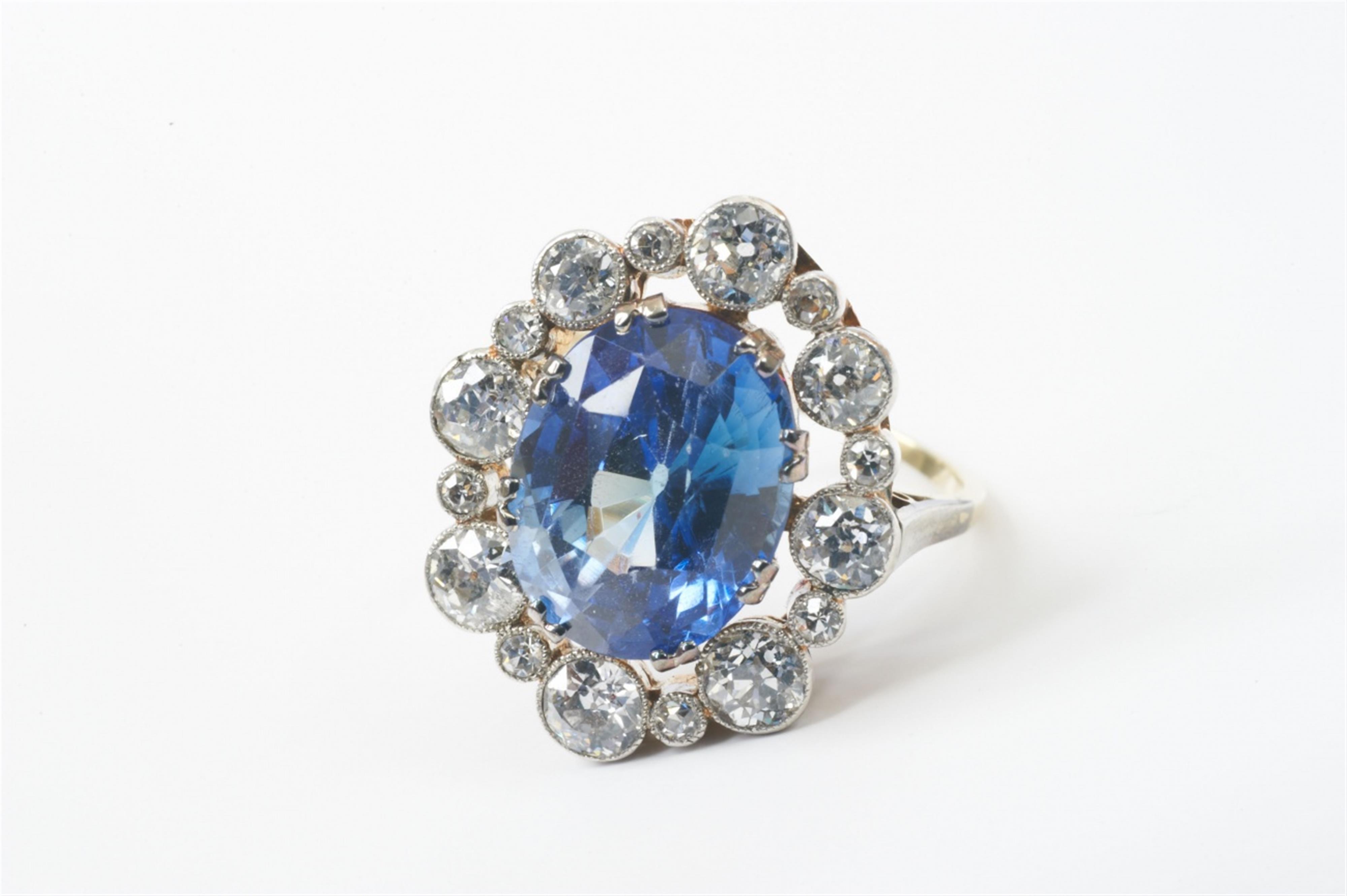 A 14k gold and diamond cluster ring with a synthetic sapphire - image-1