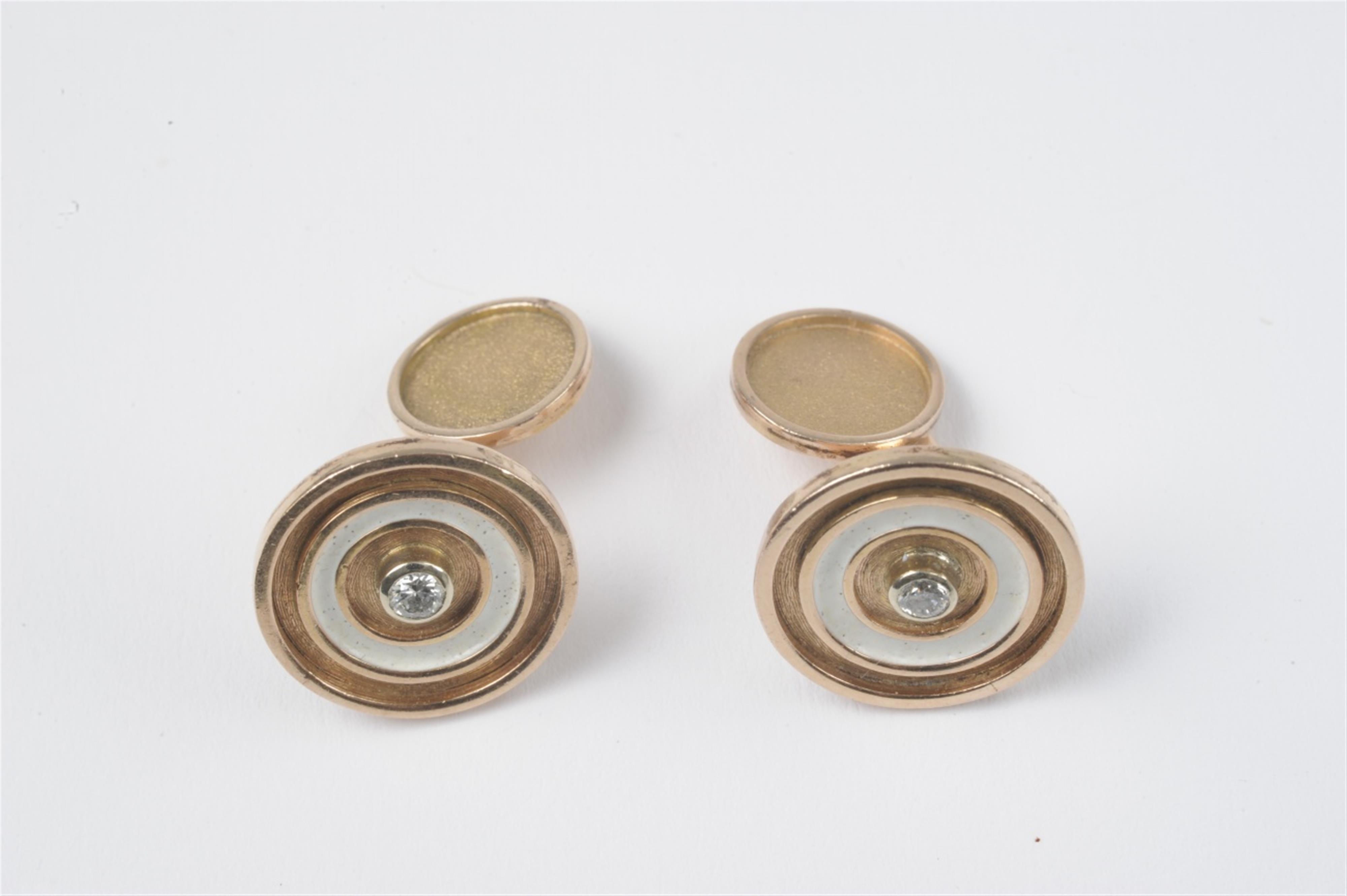 A pair of 14k gold and diamond cuff links - image-1