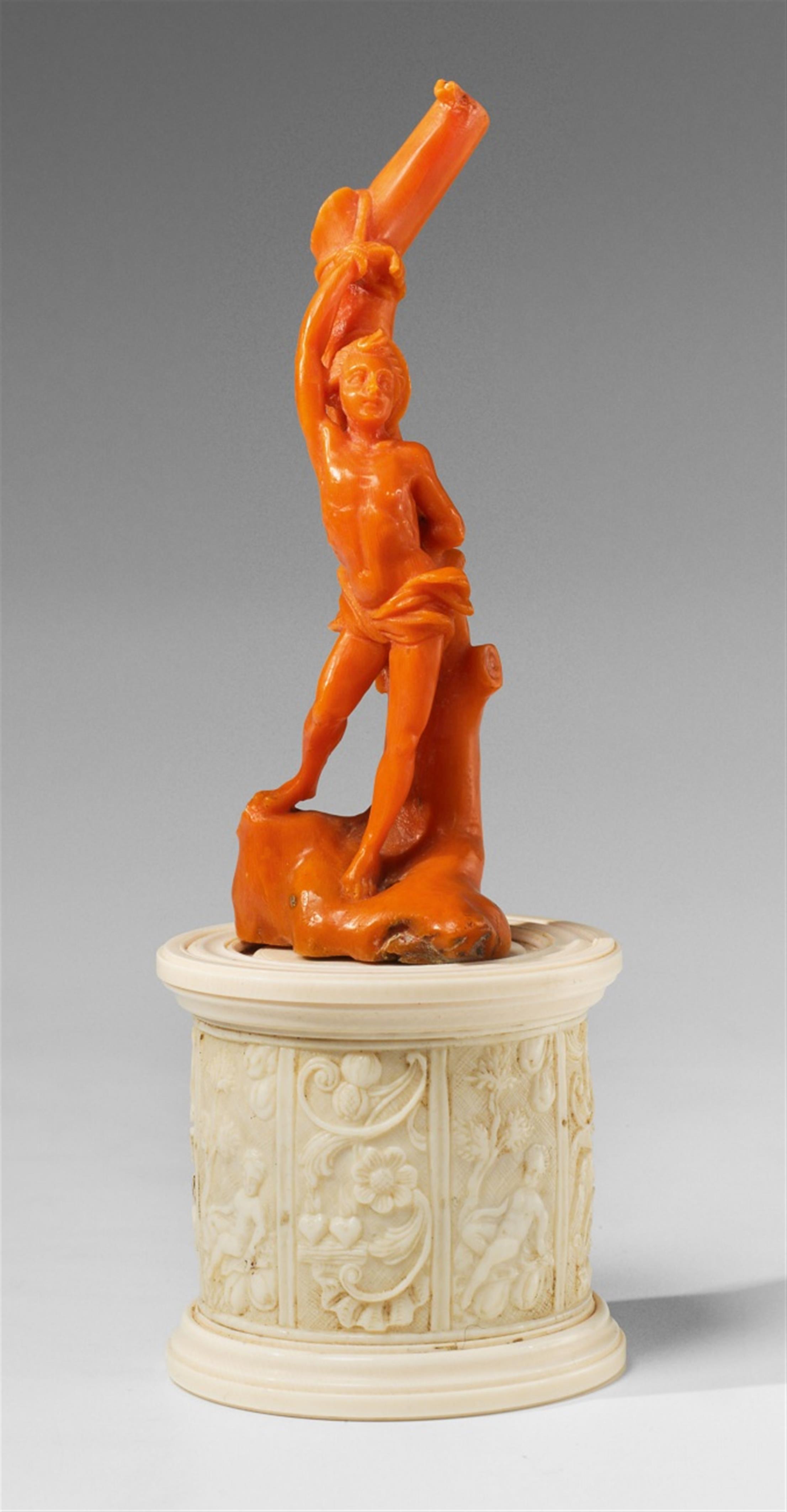 A carved red coral figure of Saint Sebastian on an ivory plinth - image-2