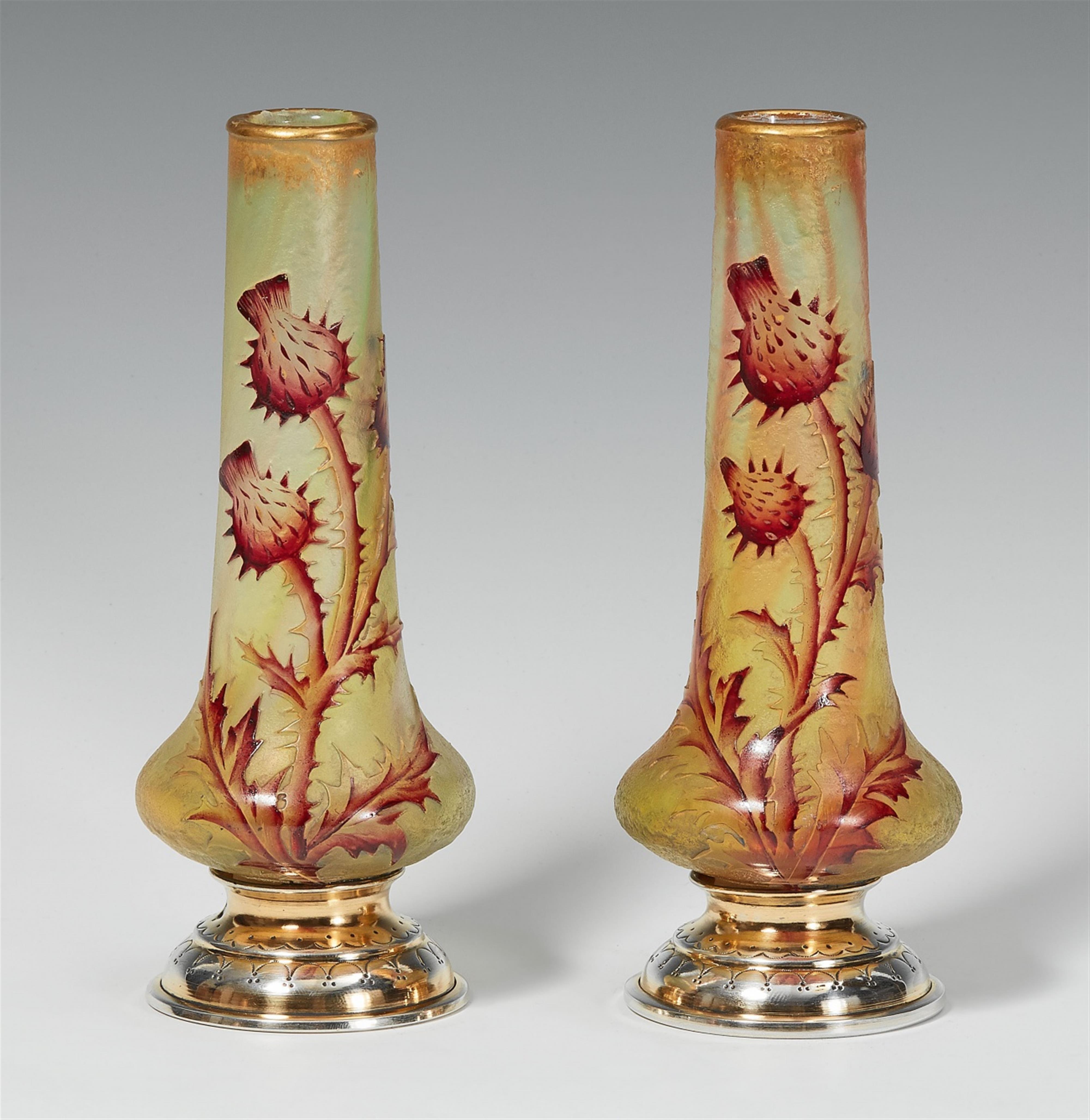 A pair of Daum Frères silver mounted glass vases with thistle decor - image-1