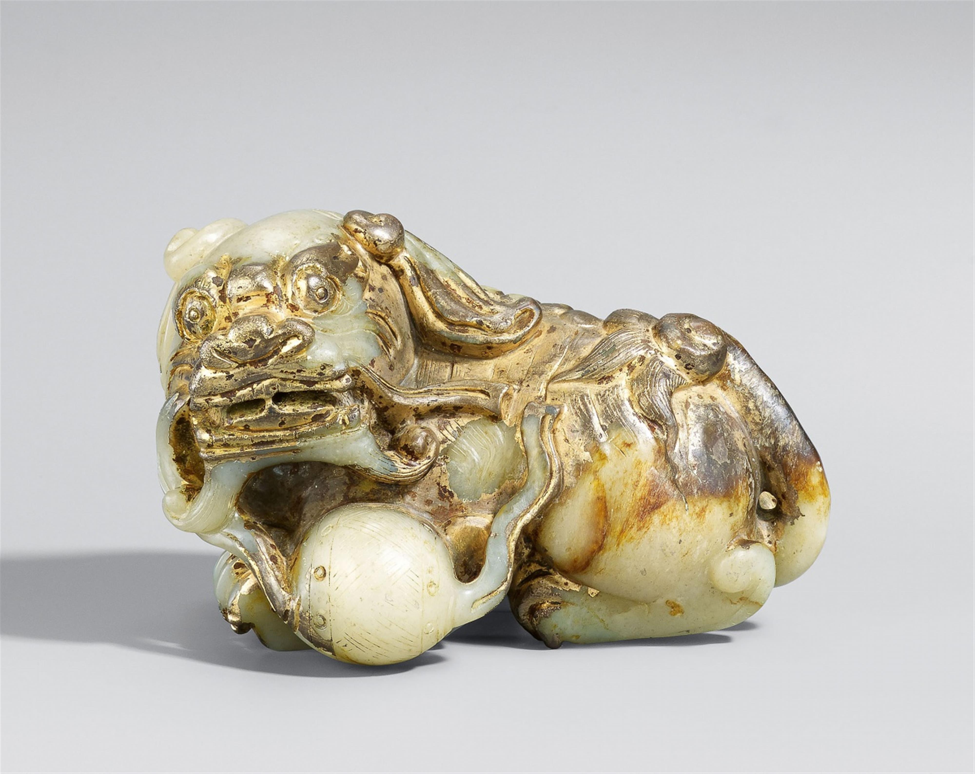 A large grey-green and brown jade carving of a Buddhist lion - image-1