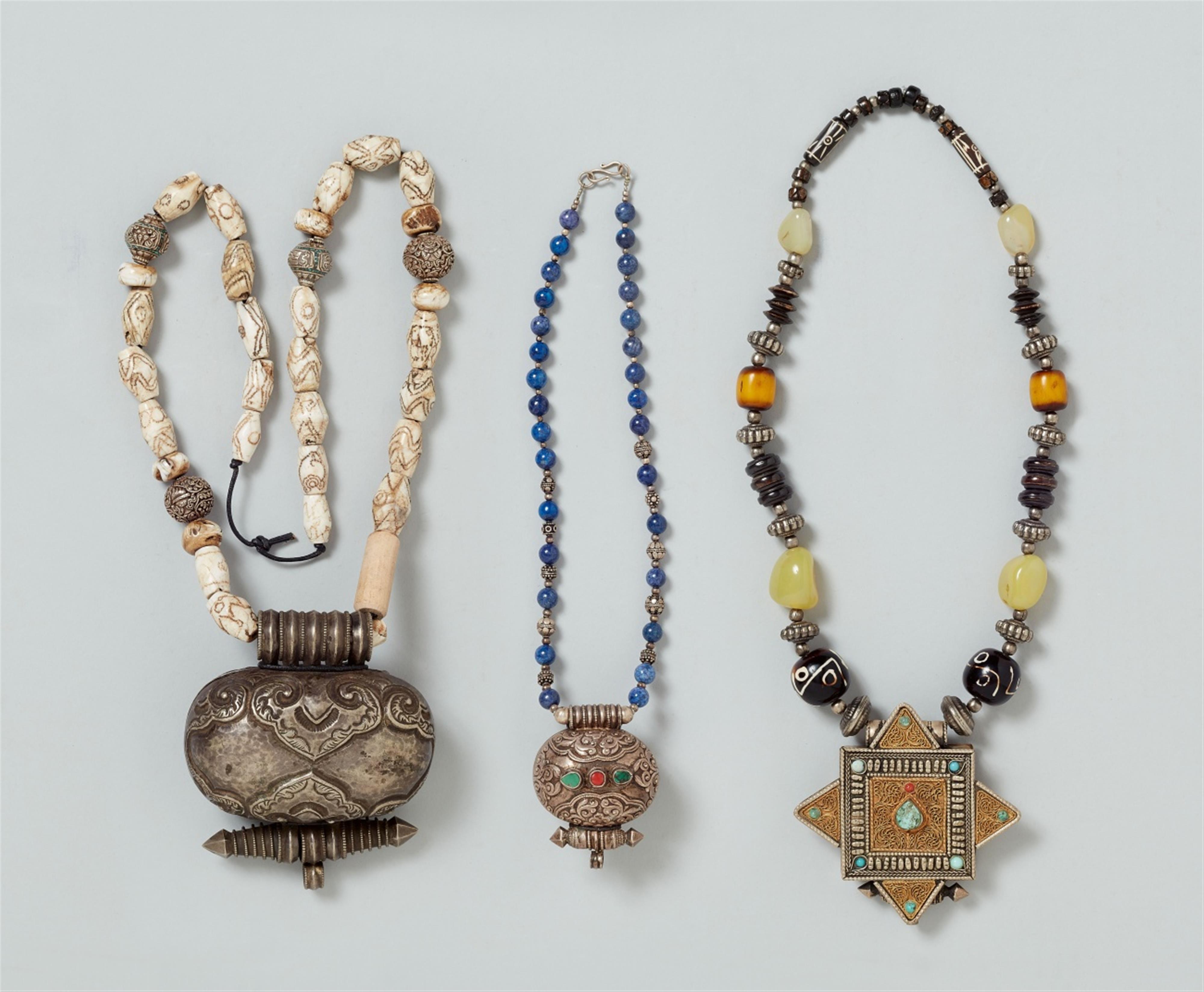 Three Tibetan silver and metal amulet boxes, ke-ga´u (neck ga´u) - image-1