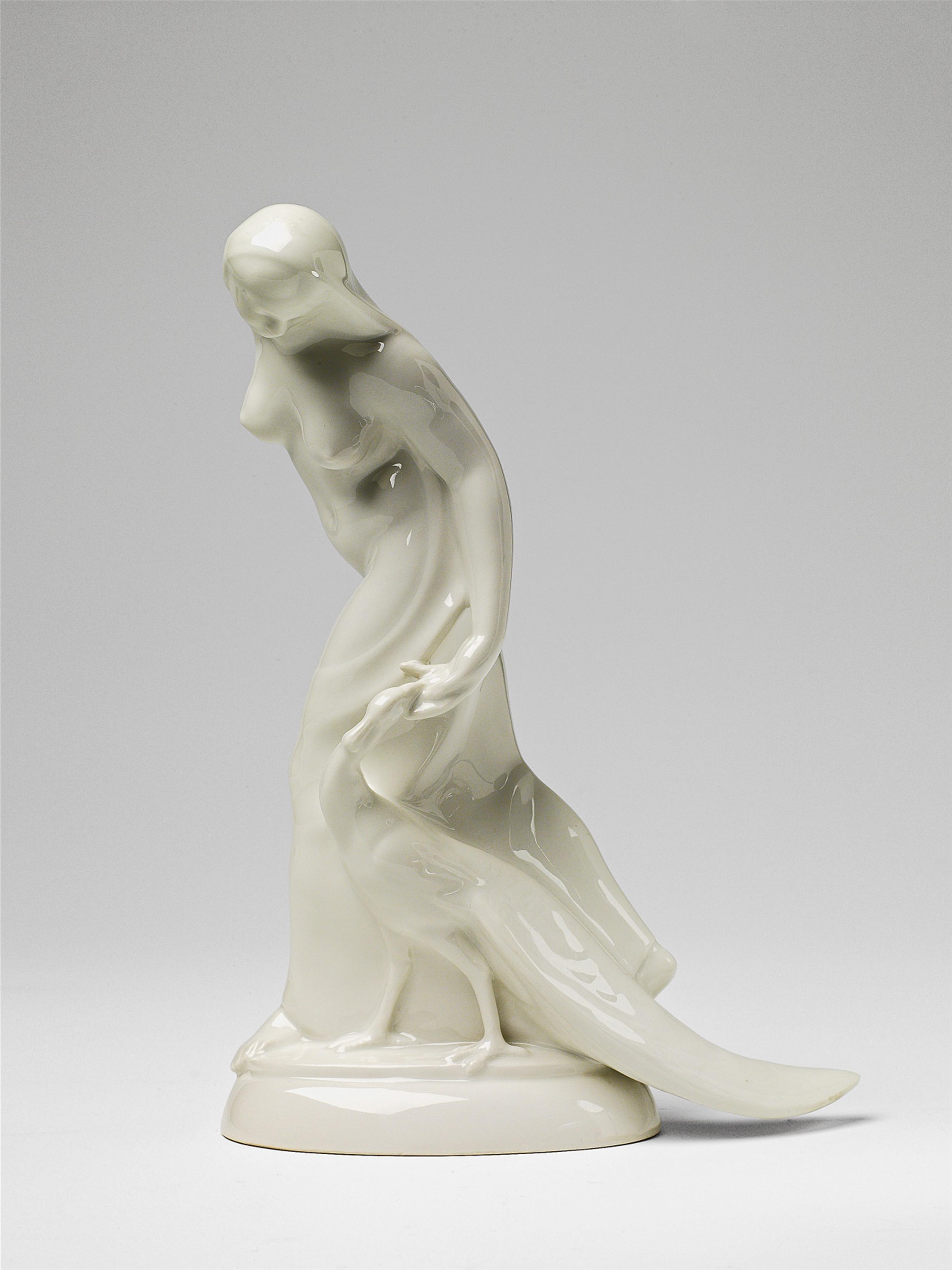 A Berlin KPM white porcelain figure of an Indian lady with a peacock - image-1