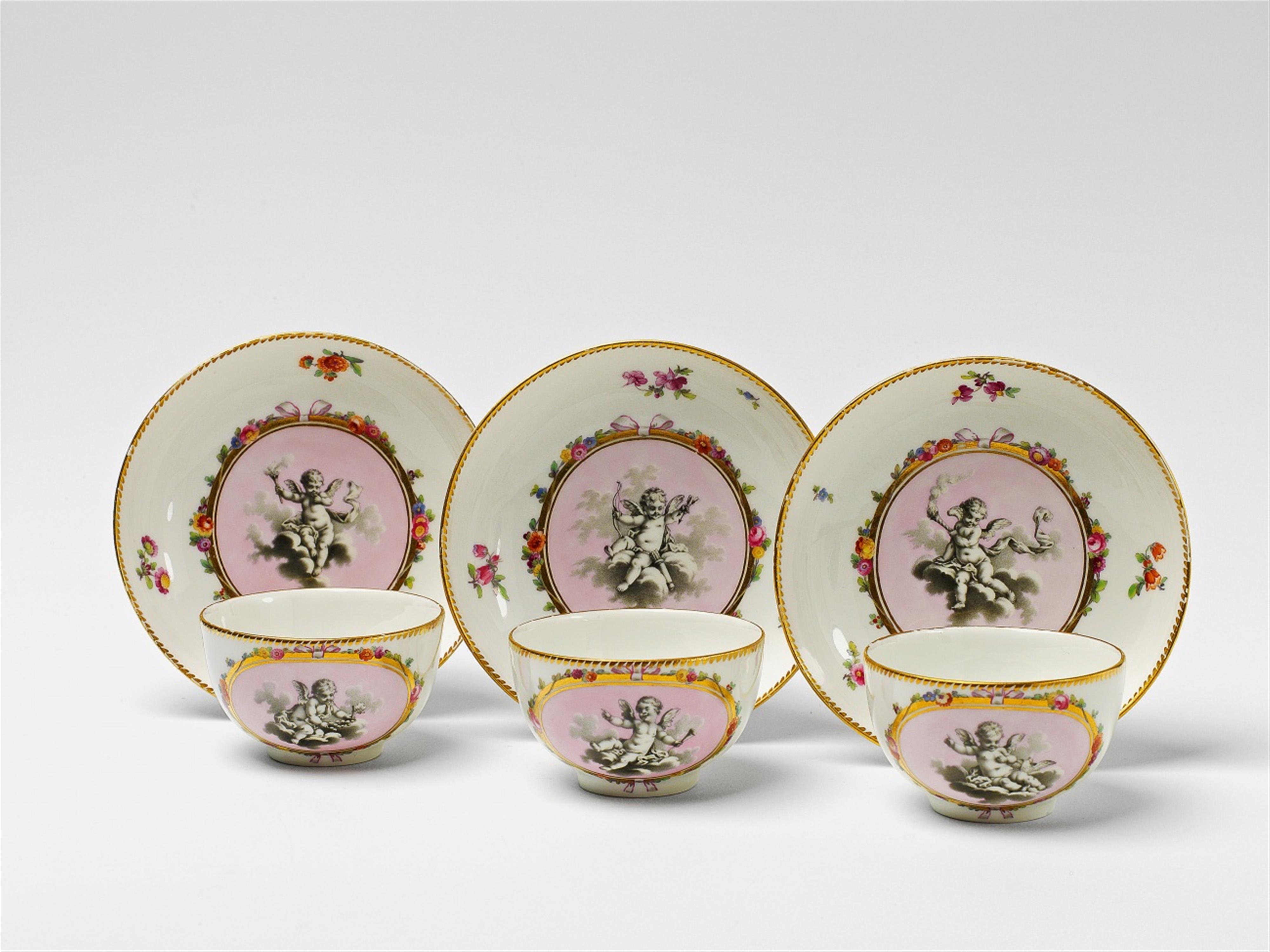 Three Berlin KPM porcelain cups and saucers with putti - image-1