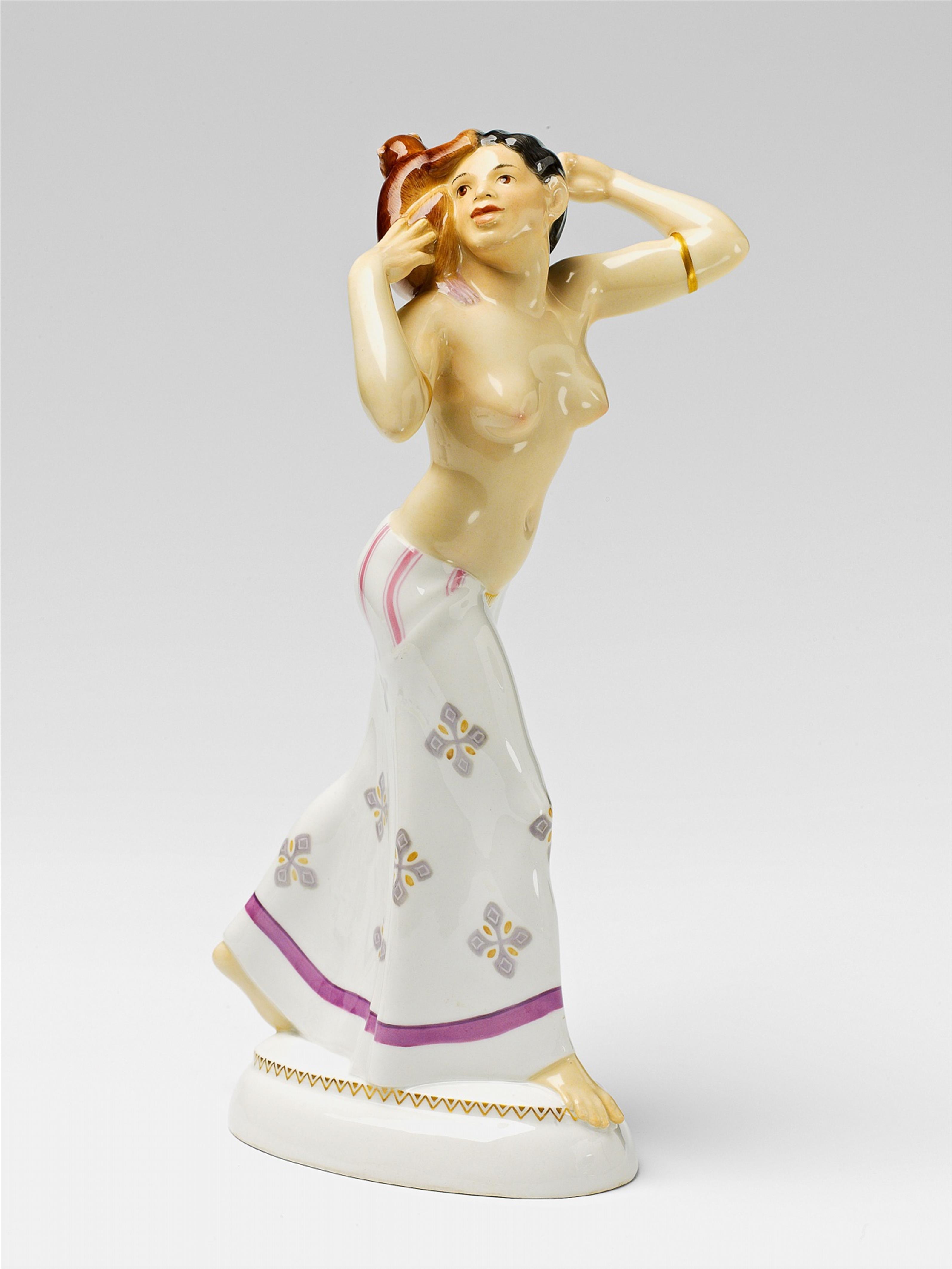 A Berlin KPM porcelain model of an African lady with a monkey - image-1