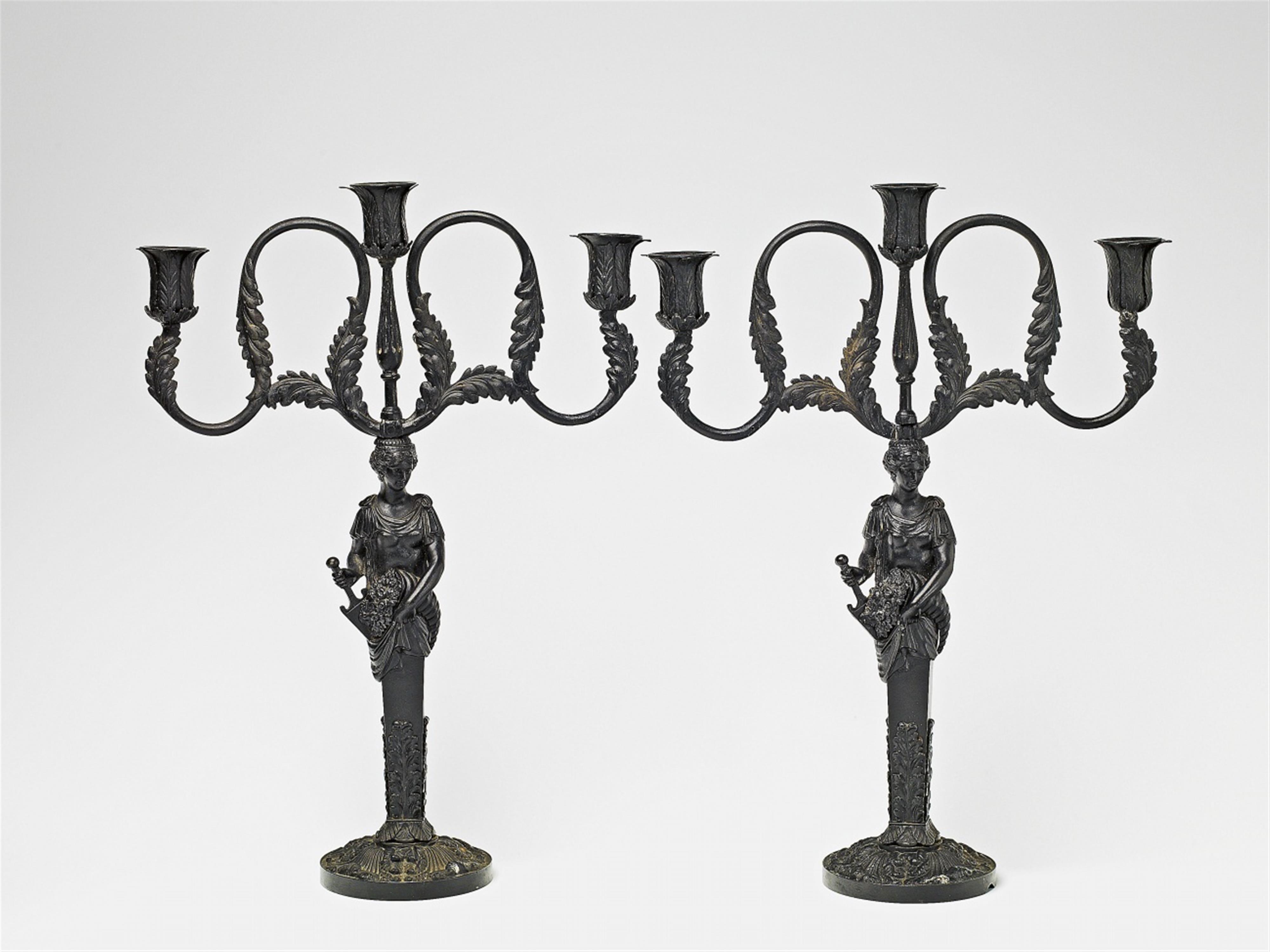 A pair of cast iron candelabra - image-1
