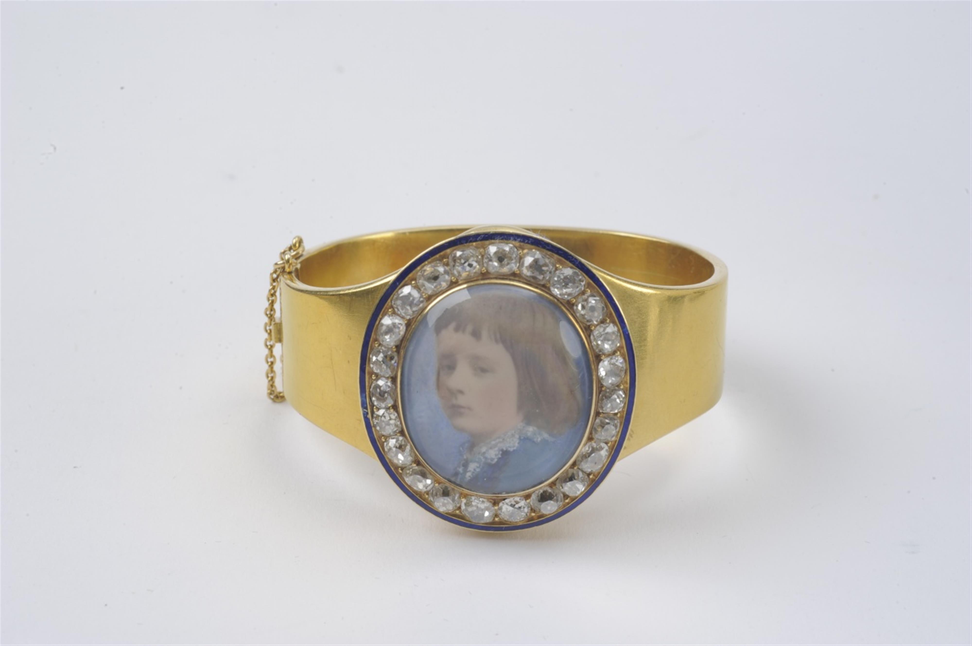 A 14k gold memorial bracelet with a portrait of a child - image-1