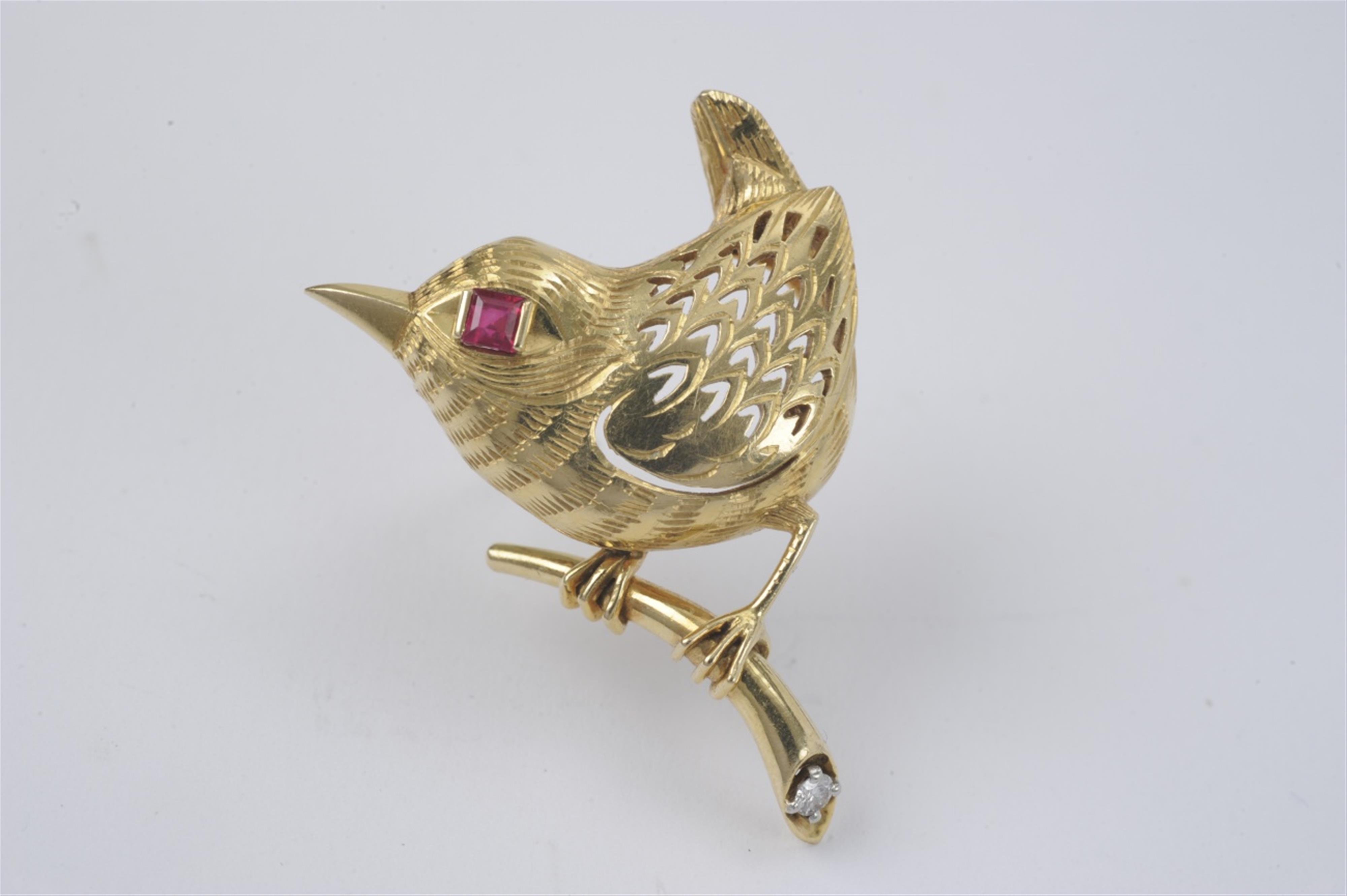 An 18k gold and ruby bird brooch by Cartier - image-1