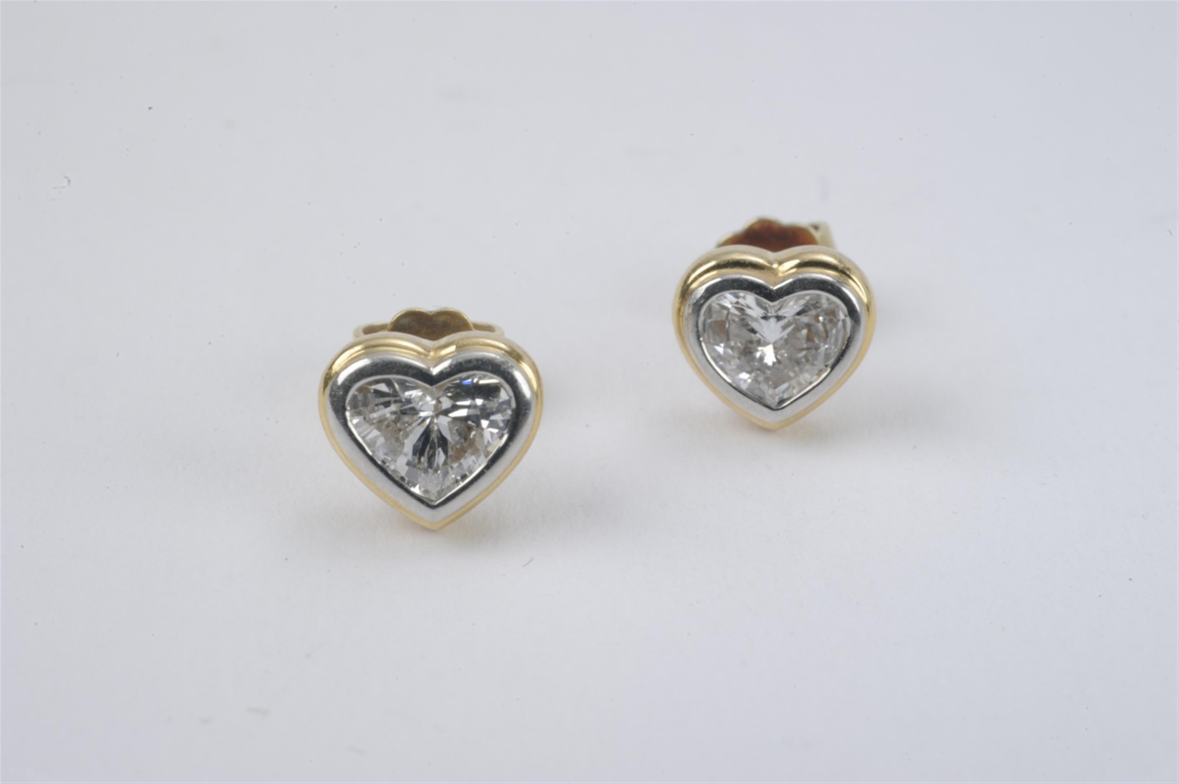 A pair of 18k white and yellow gold diamond stud earrings - image-1