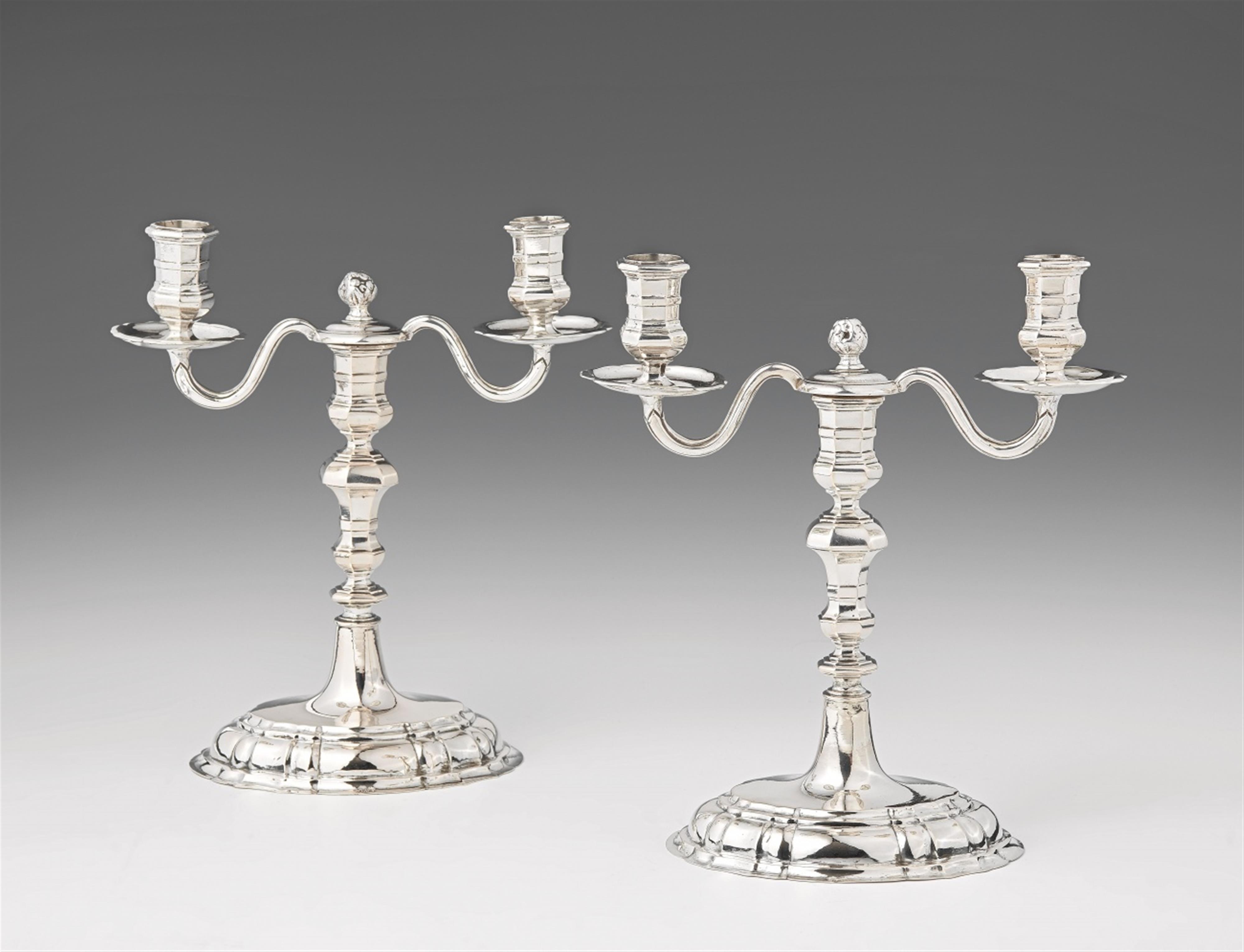 A pair of Breslau silver candlesticks with candelabra branch attachments - image-1