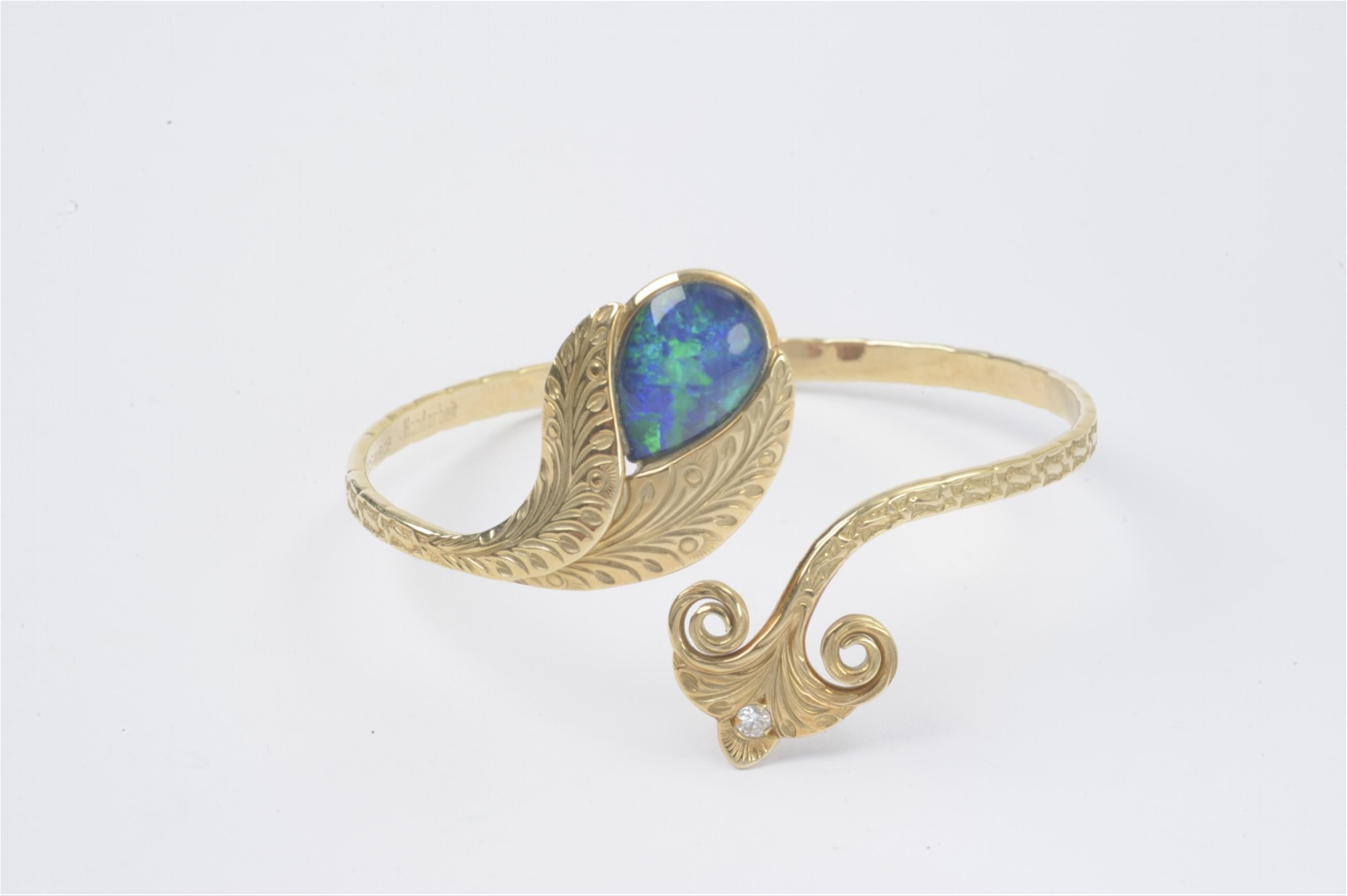 An 18k gold and opal crossover bangle - image-1