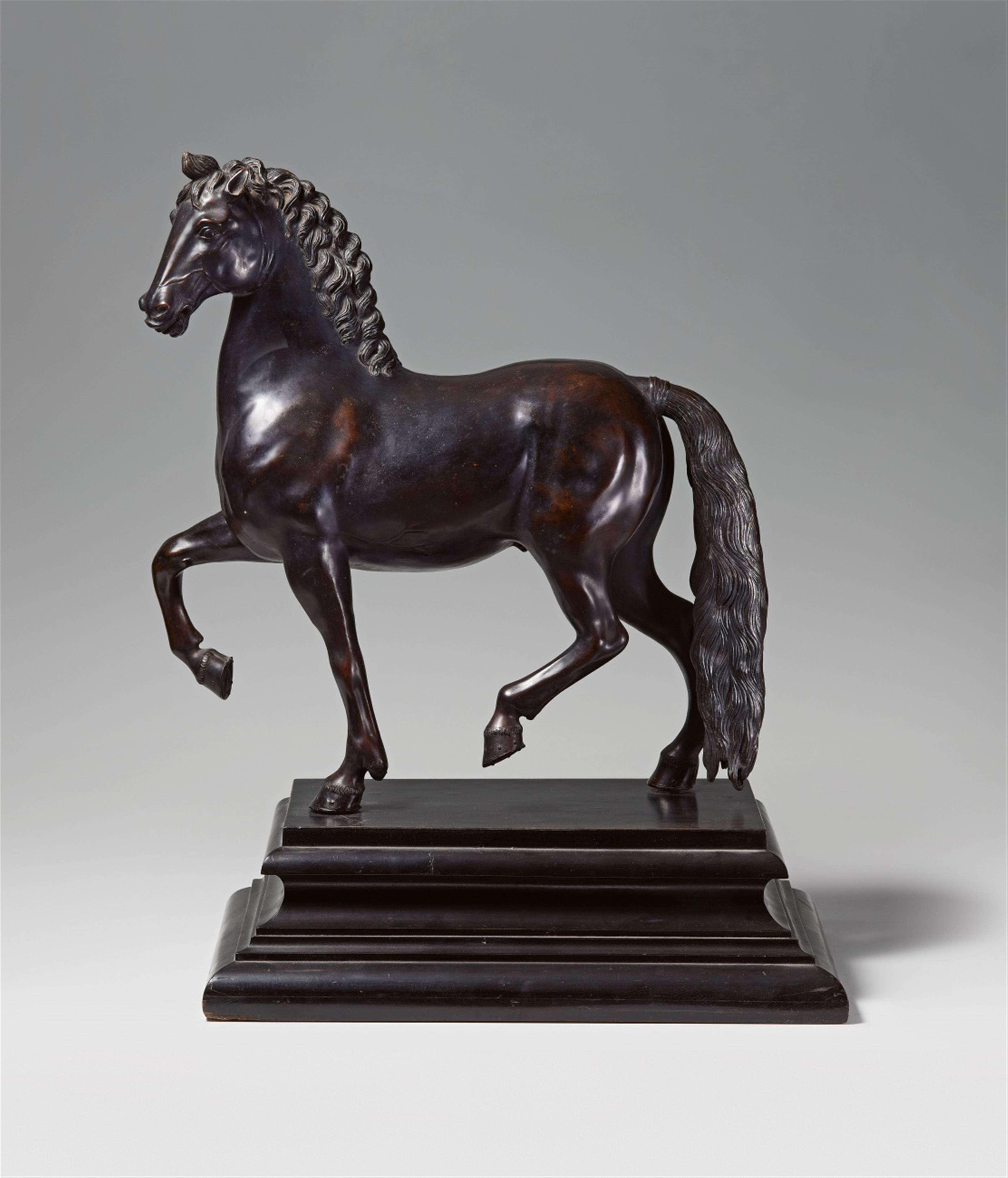 A bronze figure of a pacing stallion - image-1