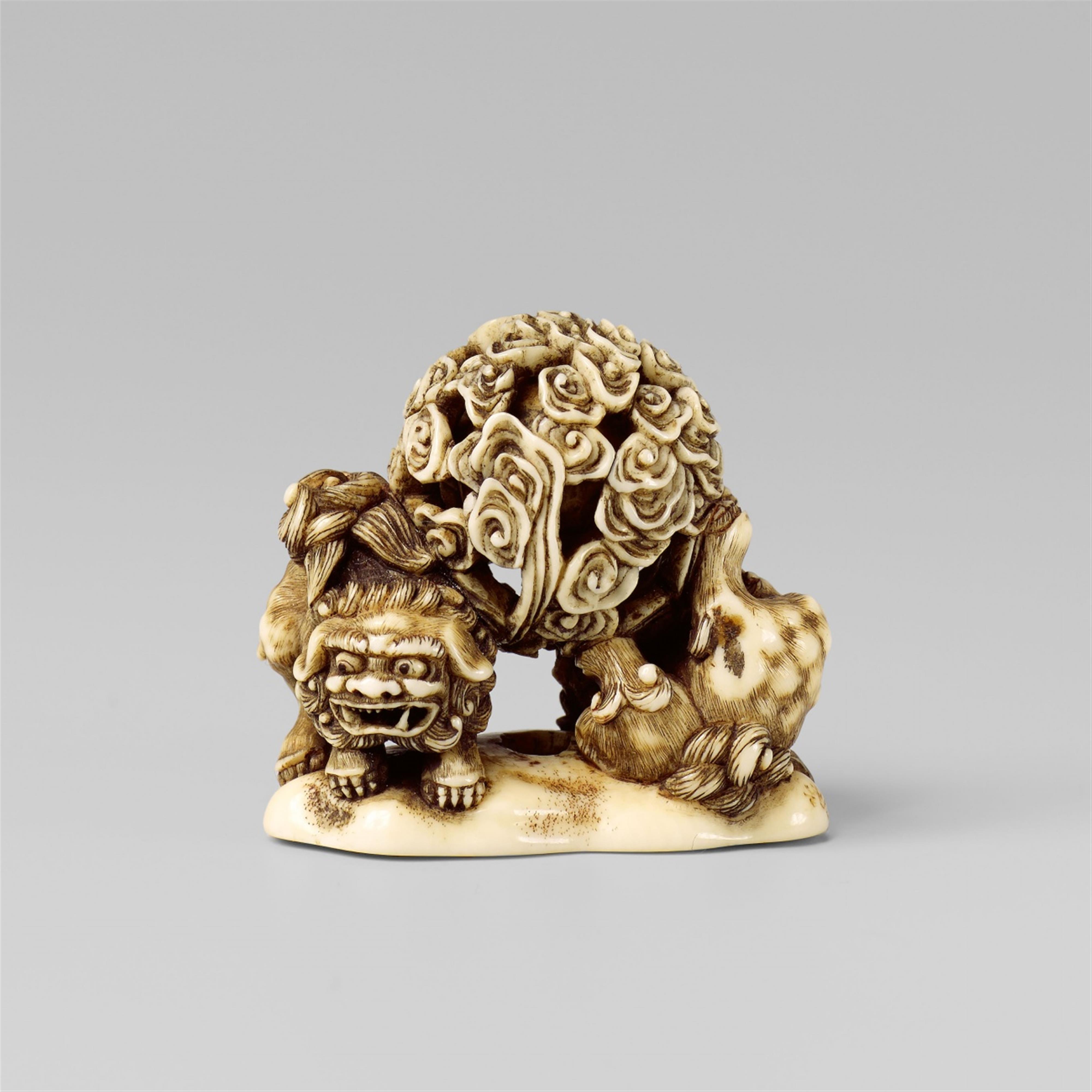An amusing and unusual ivory netsuke of two shishi with a ball, by Hidemasa. Early 19th century - image-1