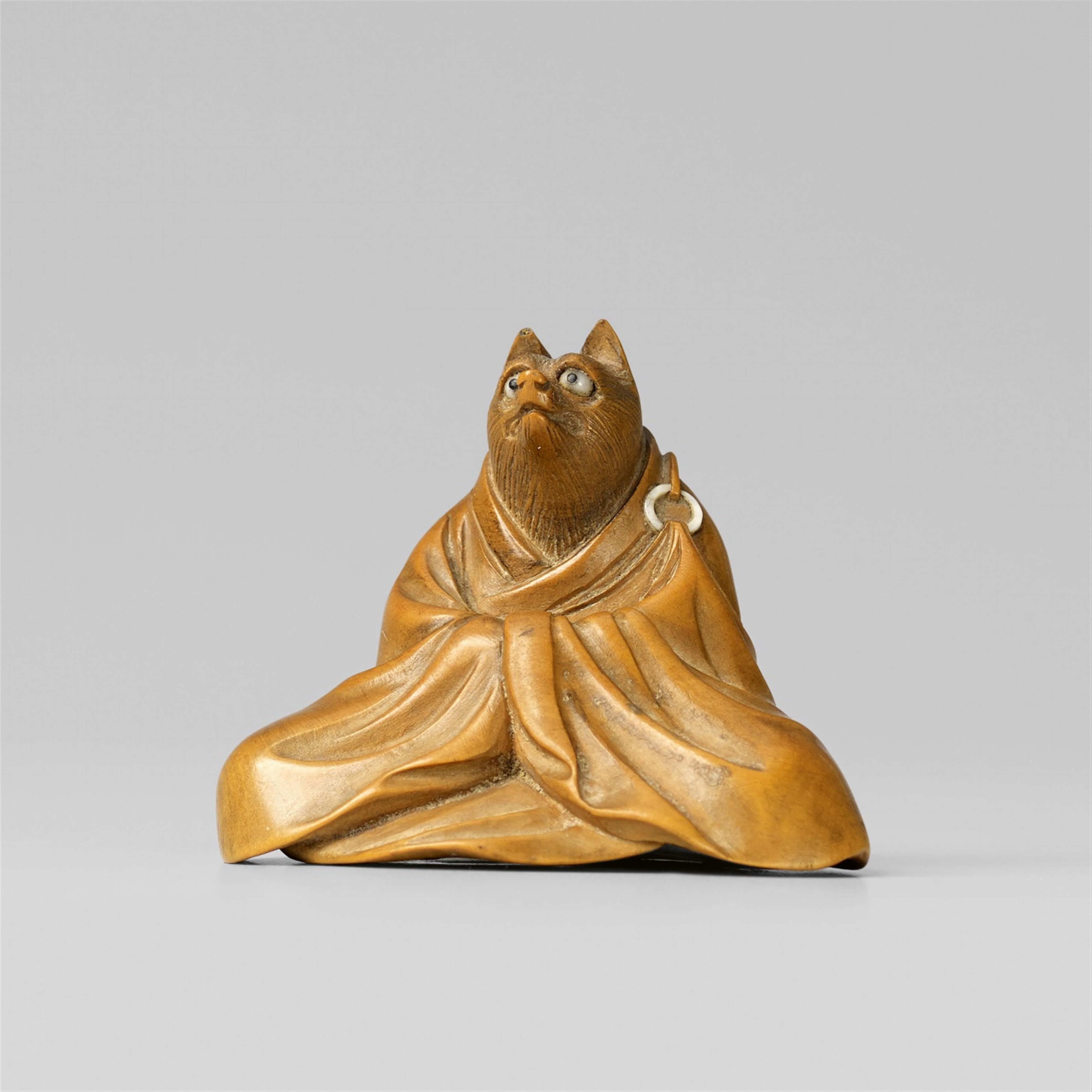 A boxwood netsuke of a sly fox as a priest. Late 19th century - image-1