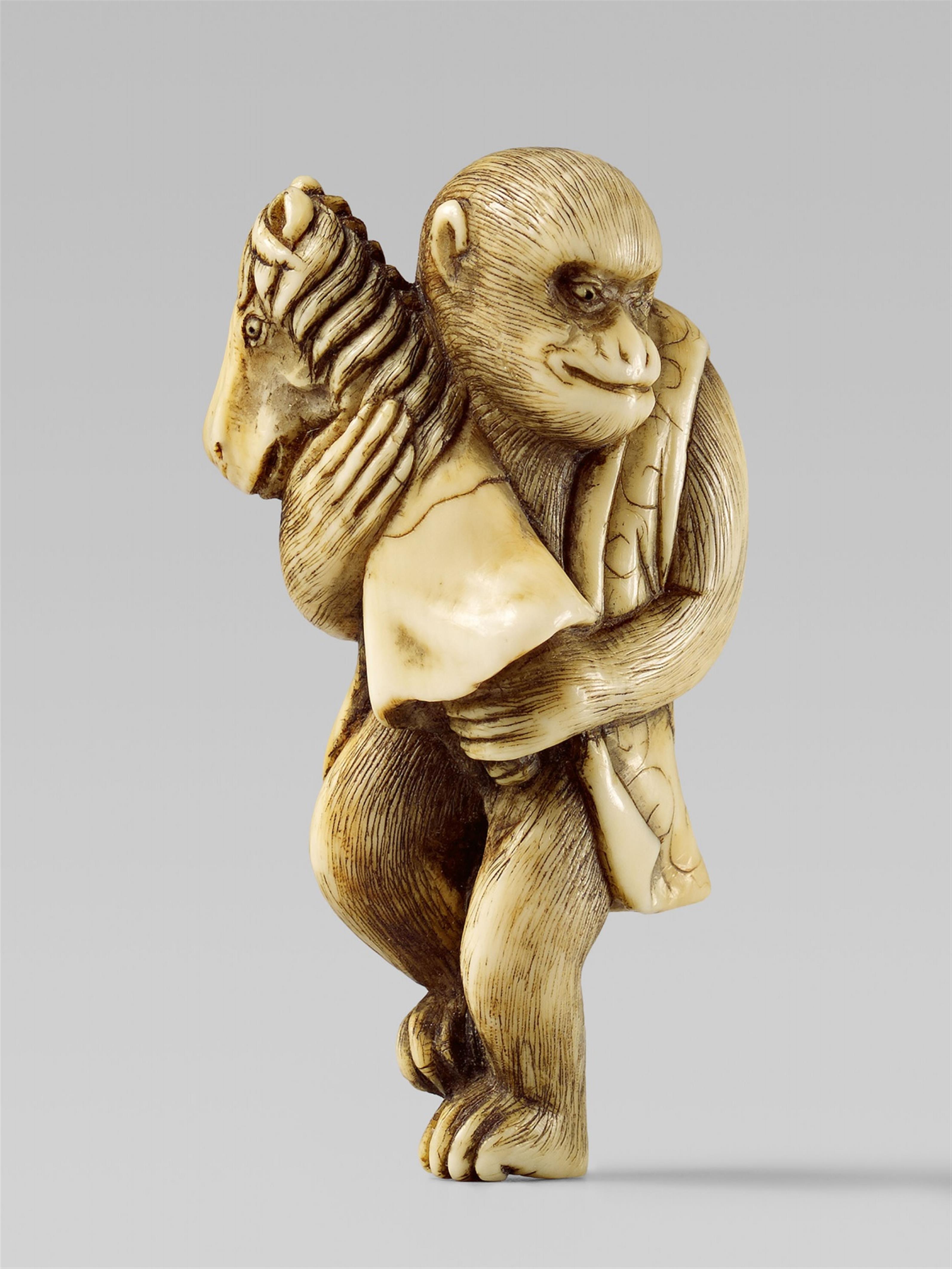 An ivory netsuke of a monkey with a hobbyhorse. First half 19th century - image-1