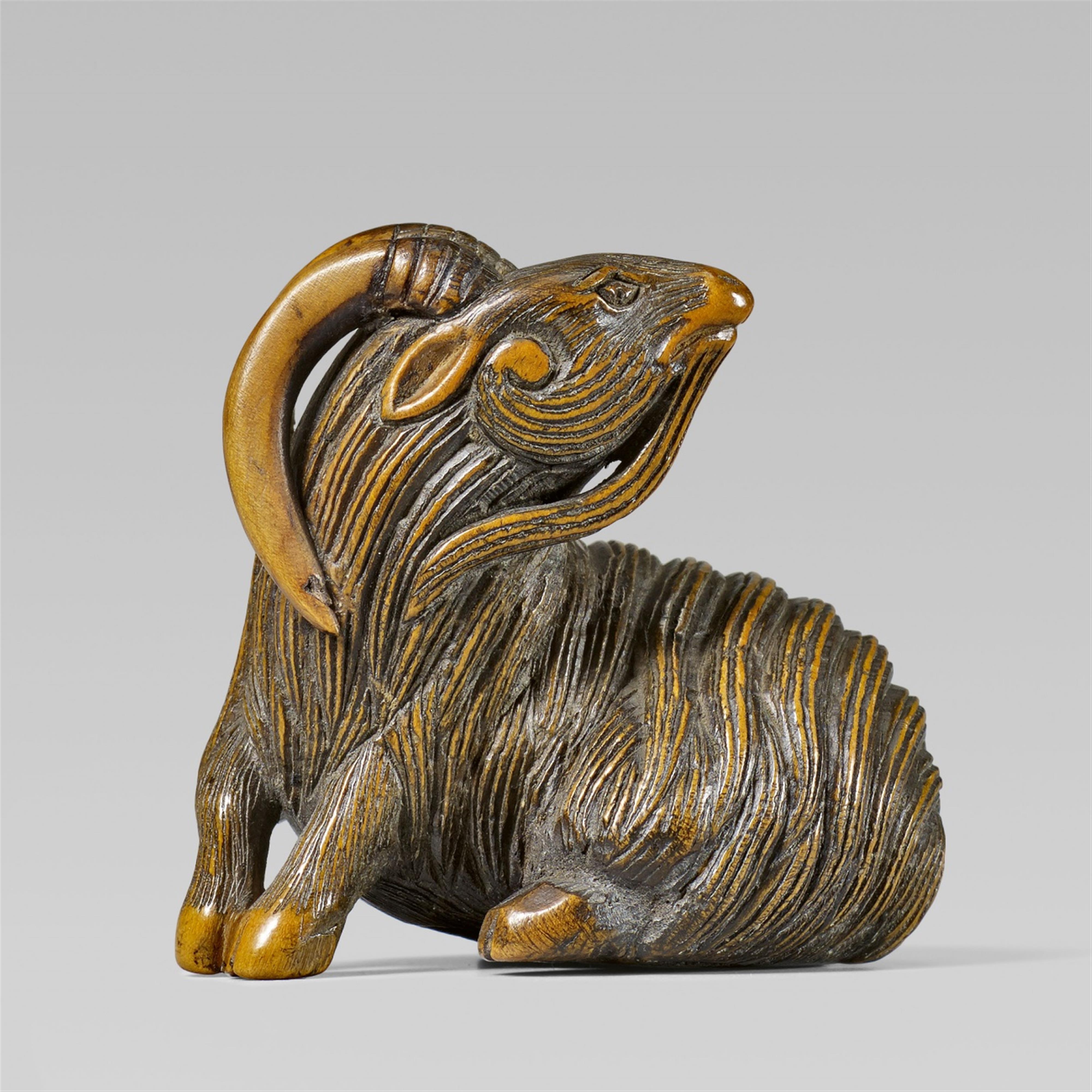 A boxwood netsuke of a recumbent, long-haired goat. 19th century - image-1