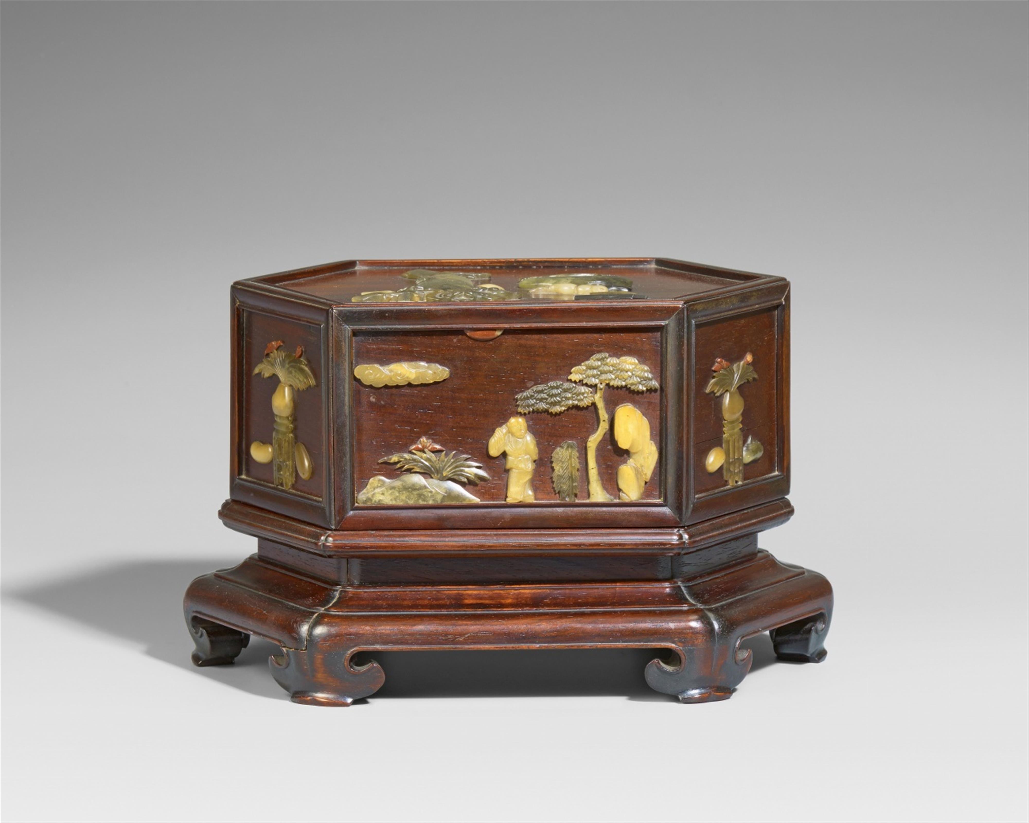 An octaconal soapstone-inlaid wood lidded box on an integral base - image-1