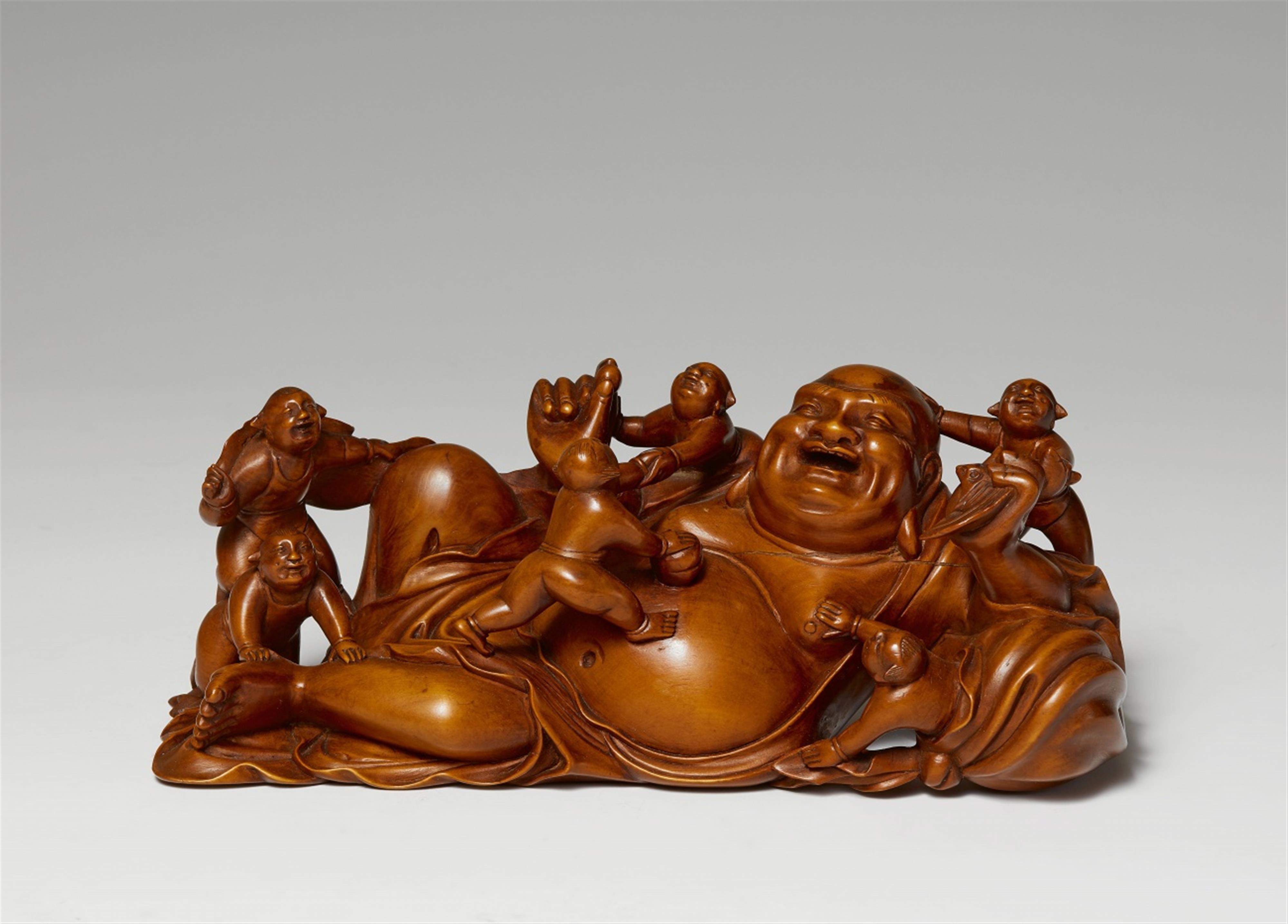 A wood figure of a reclining Budai. 20th century - image-1